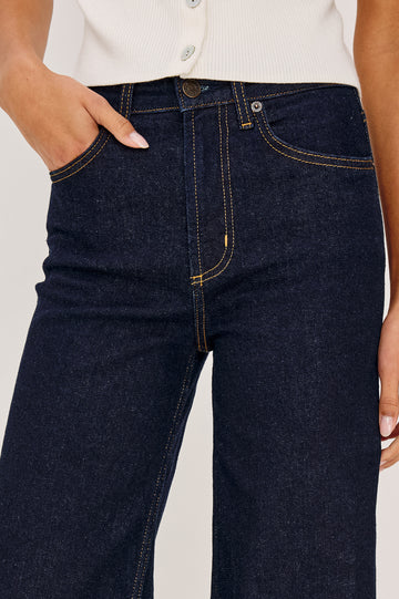 Getty Wide Leg Jean in Light Stretch Denim With High-Rise High-Waisted Fit, Button Fly, and 5-Pockets in Midnight Blues Cuffed Colorway - Lower Body Front View Featured on Model