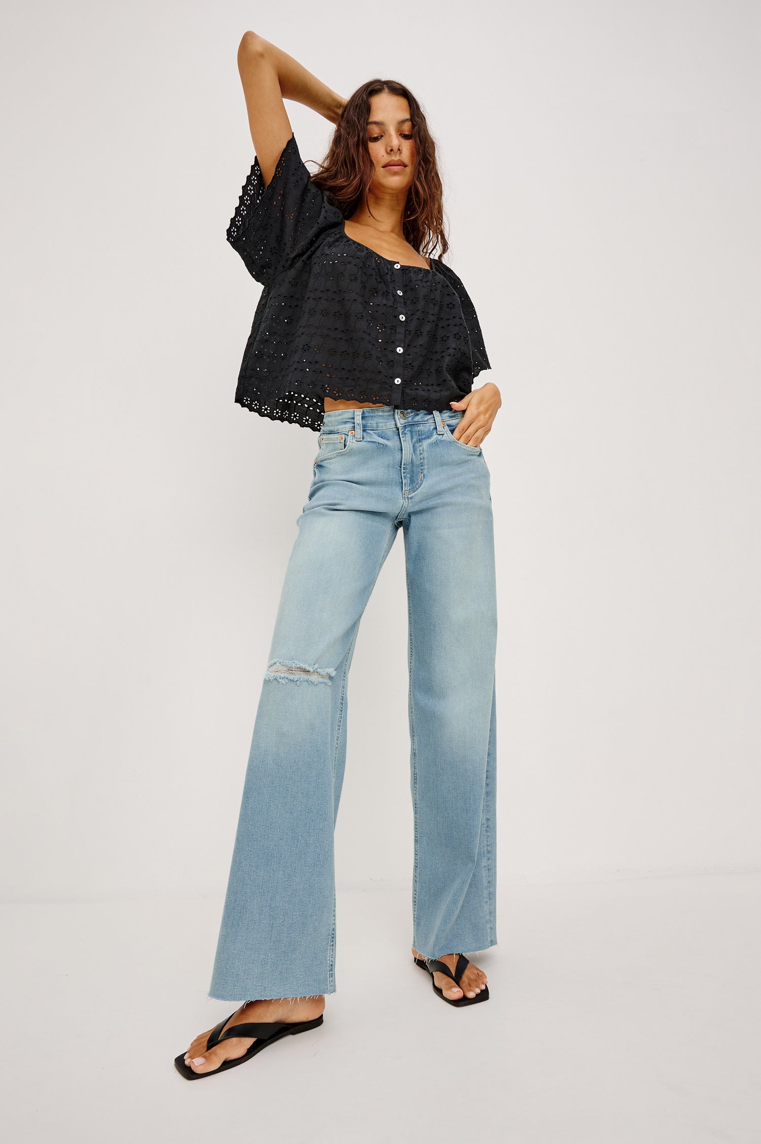 Getty Wide Leg Jean in Light Stretch Denim With Mid-Rise, 5-Pockets, Distressed Detailing, and Raw Hem in Waverider Colorway - Full Body Front View Featured on Model