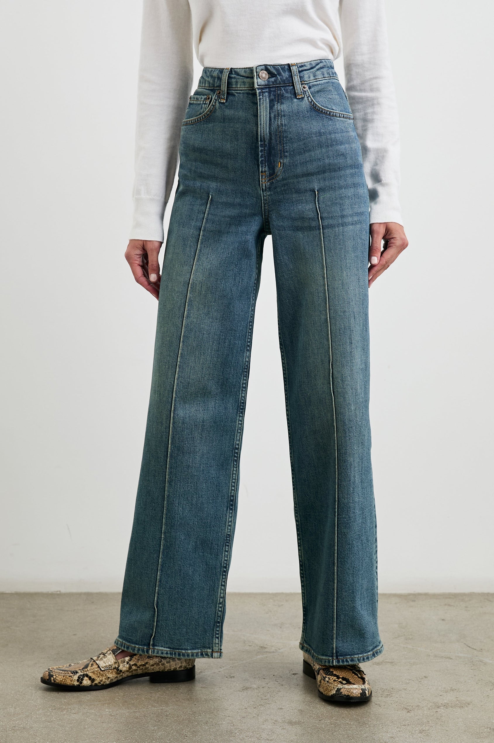 Getty Pintuck Wide Leg Denim Pants with a Vertical Center Front and Back Leg Seam, Belt Loops, Two Front Pockets and Two Back Patch Pockets in Authentic Blue Colorway - Front View Featured on Model