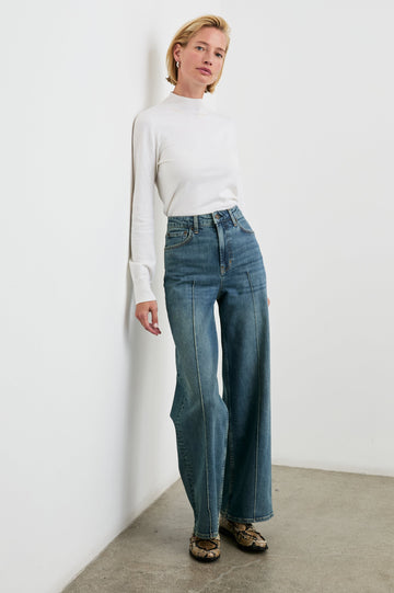 Getty Pintuck Wide Leg Denim Pants with a Vertical Center Front and Back Leg Seam, Belt Loops, Two Front Pockets and Two Back Patch Pockets in Authentic Blue Colorway - Front Full Body View Featured on Model