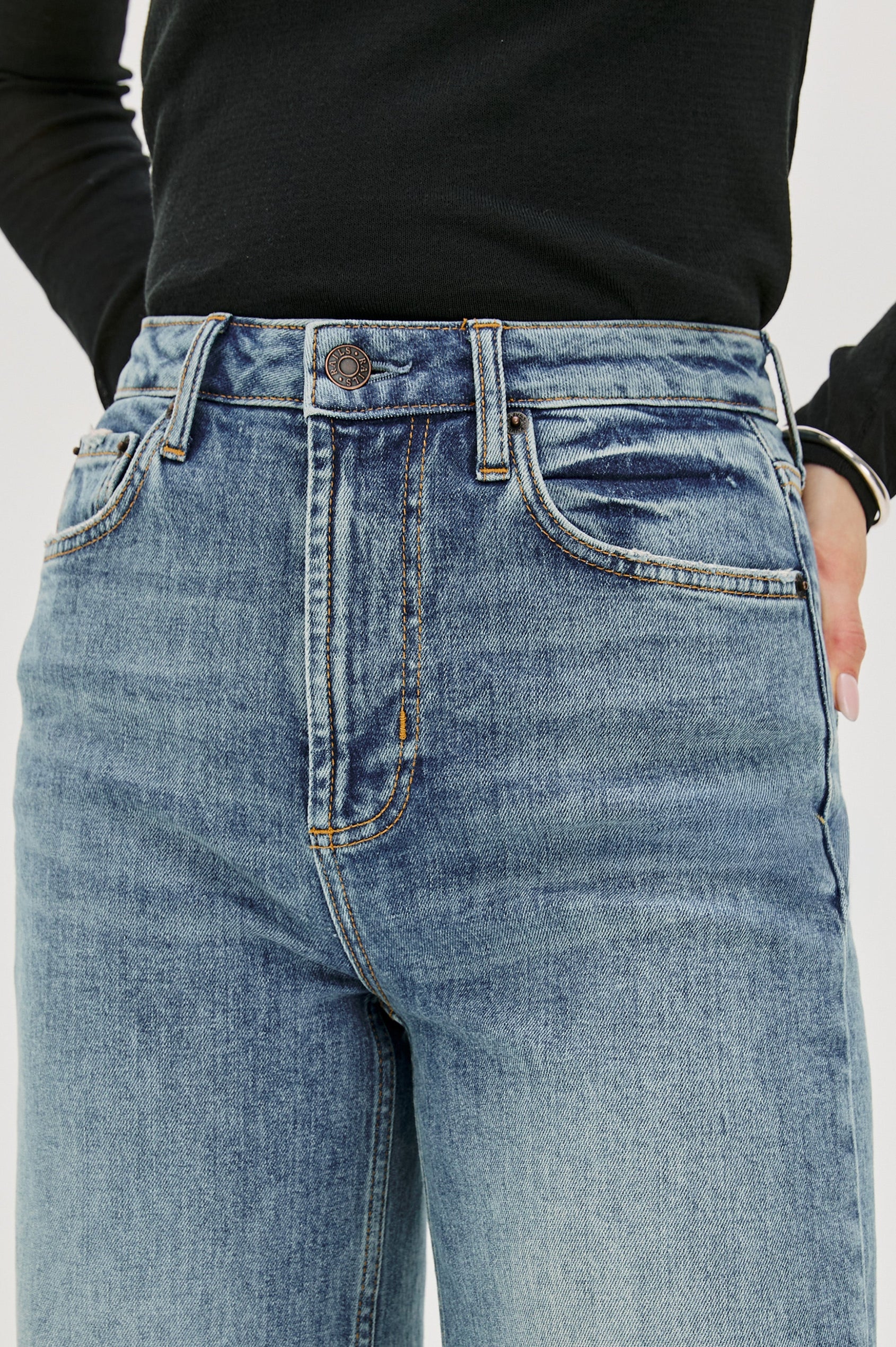 Getty full length 5-pocket wide leg jean in Tradewind colorway, a medium wash. Front detail view featured on model.