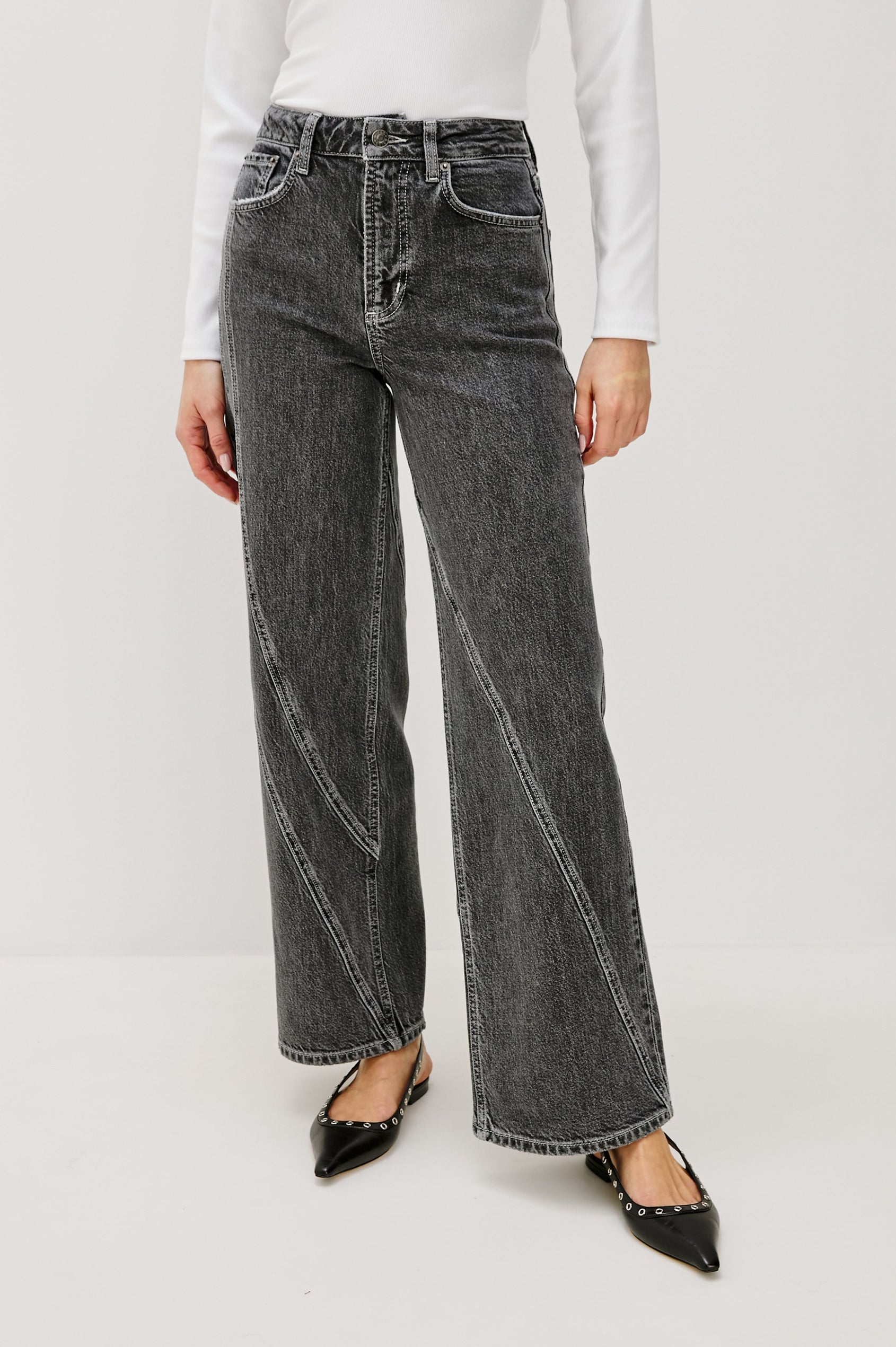 Getty Twist Seam Wide Leg Denim Pants with a Diagonal Seam Across the Leg, Belt Loops, Two Front Pockets and Two Back Patch Pockets in Washed Charcoal Colorway - Front View Featured on Model