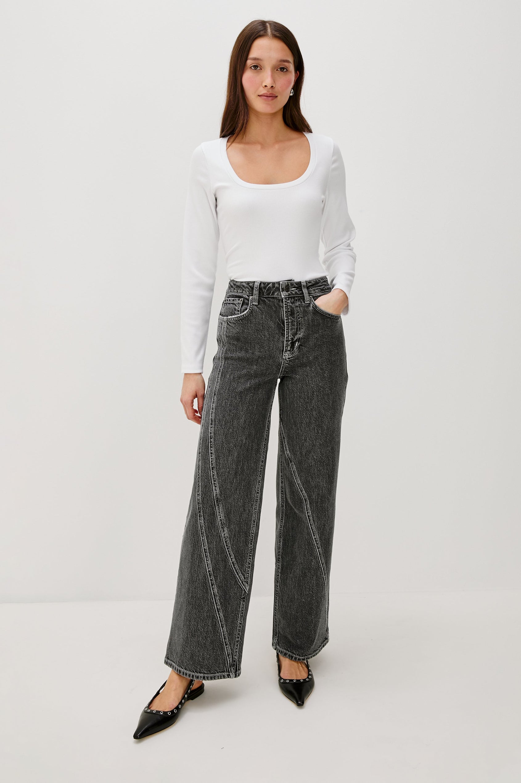 Getty Twist Seam Wide Leg Denim Pants with a Diagonal Seam Across the Leg, Belt Loops, Two Front Pockets and Two Back Patch Pockets in Washed Charcoal Colorway - Front Full Body View Featured on Model