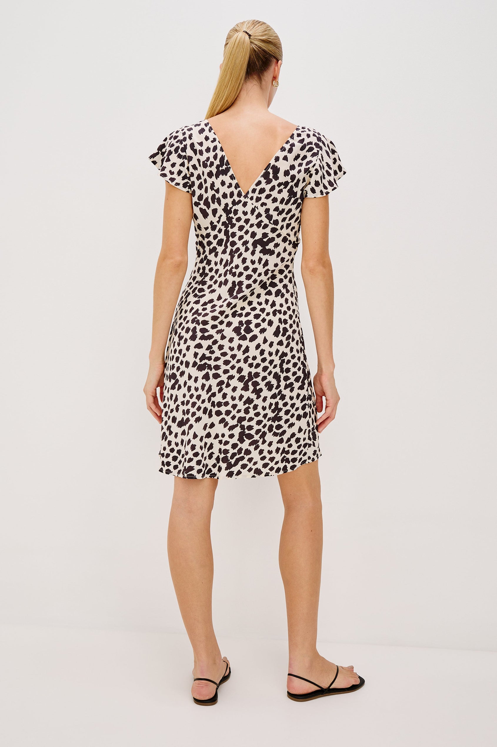 Gigi V-Neck Mini Dress with Short Flutter Sleeves, Empire Waist  in Taupe Spotted Colorway. Full Body Back View Shown on Model.