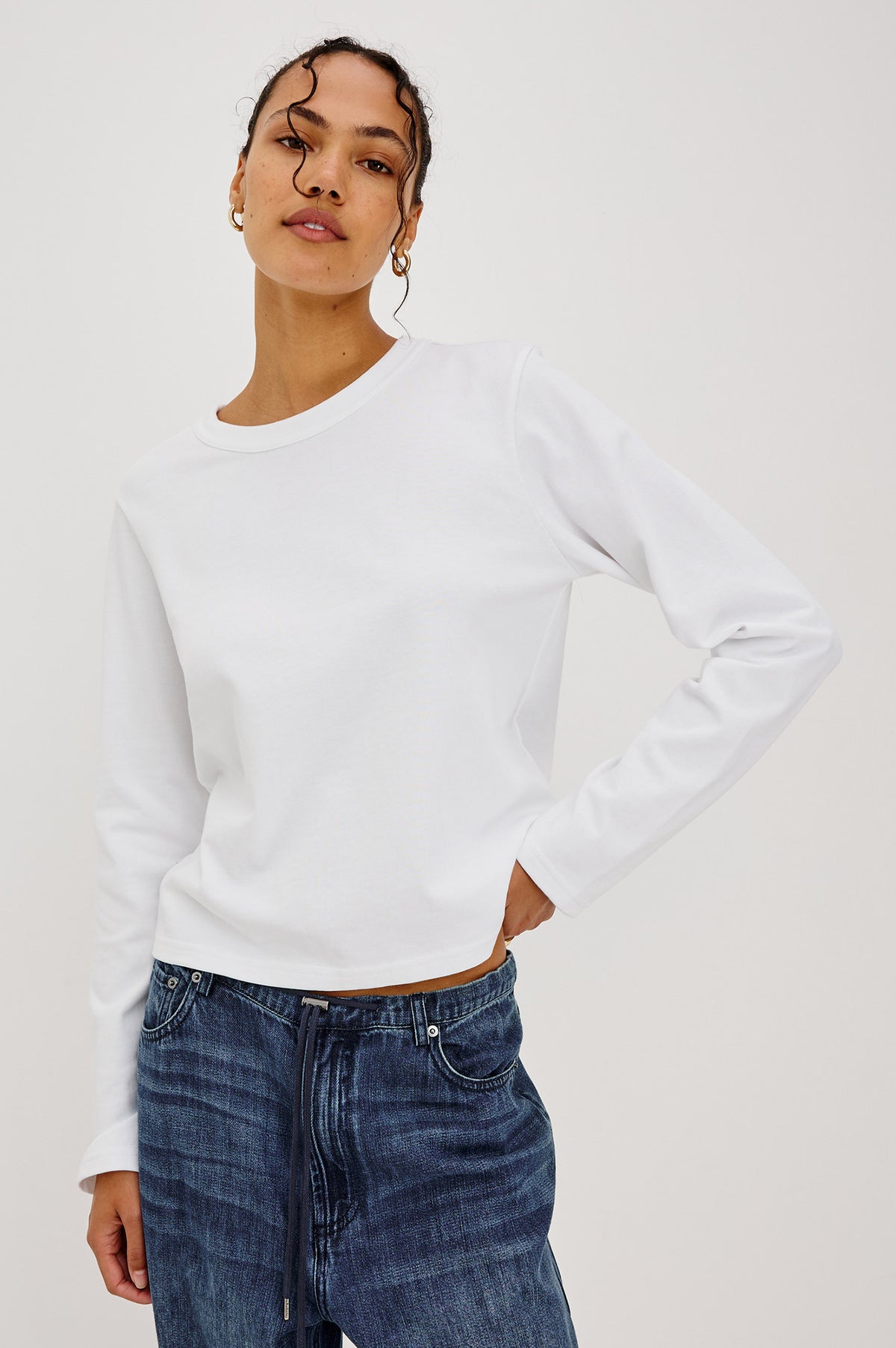 Long Sleeve Girlfriend Tee in Midweight Pleated Jersey in Slightly Boxy Cropped Fit With Crew Neckline in White Colorway - Front View Featured on Model.