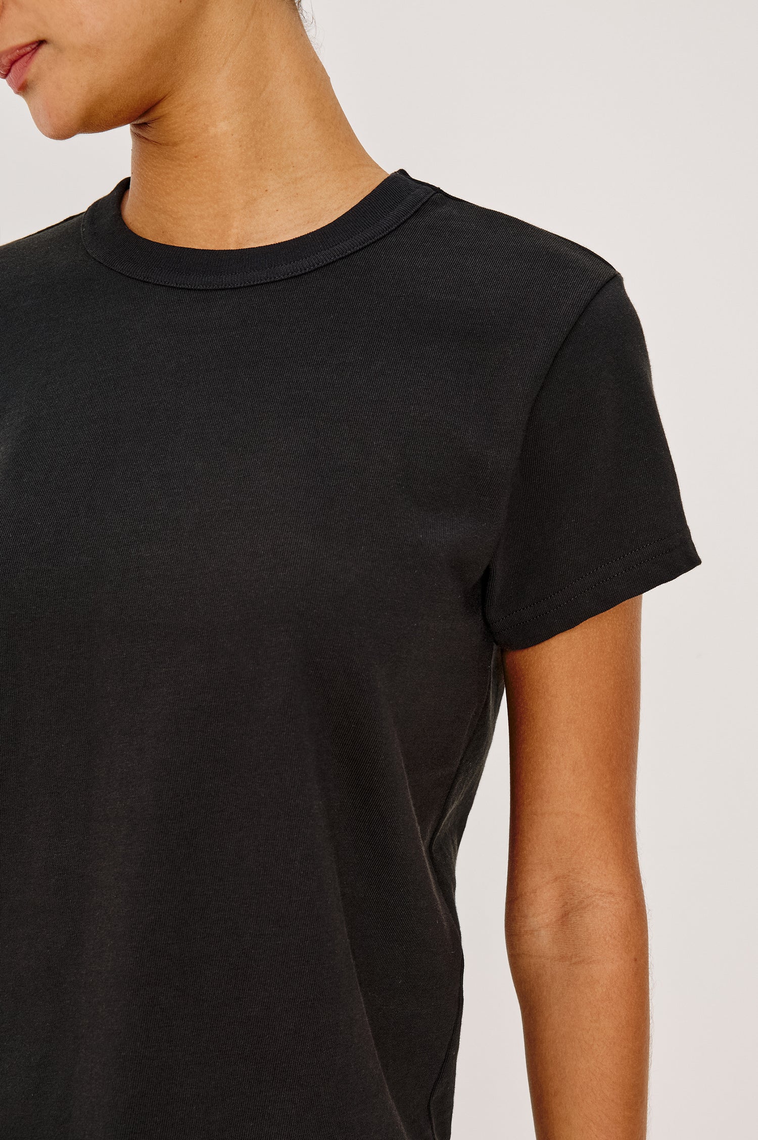 Girlfriend T-Shirt in Pleated Jersey With Slightly Boxy, Cropped Silhouette in Black Colorway - Upper Body Close Up Front View Featured on Model