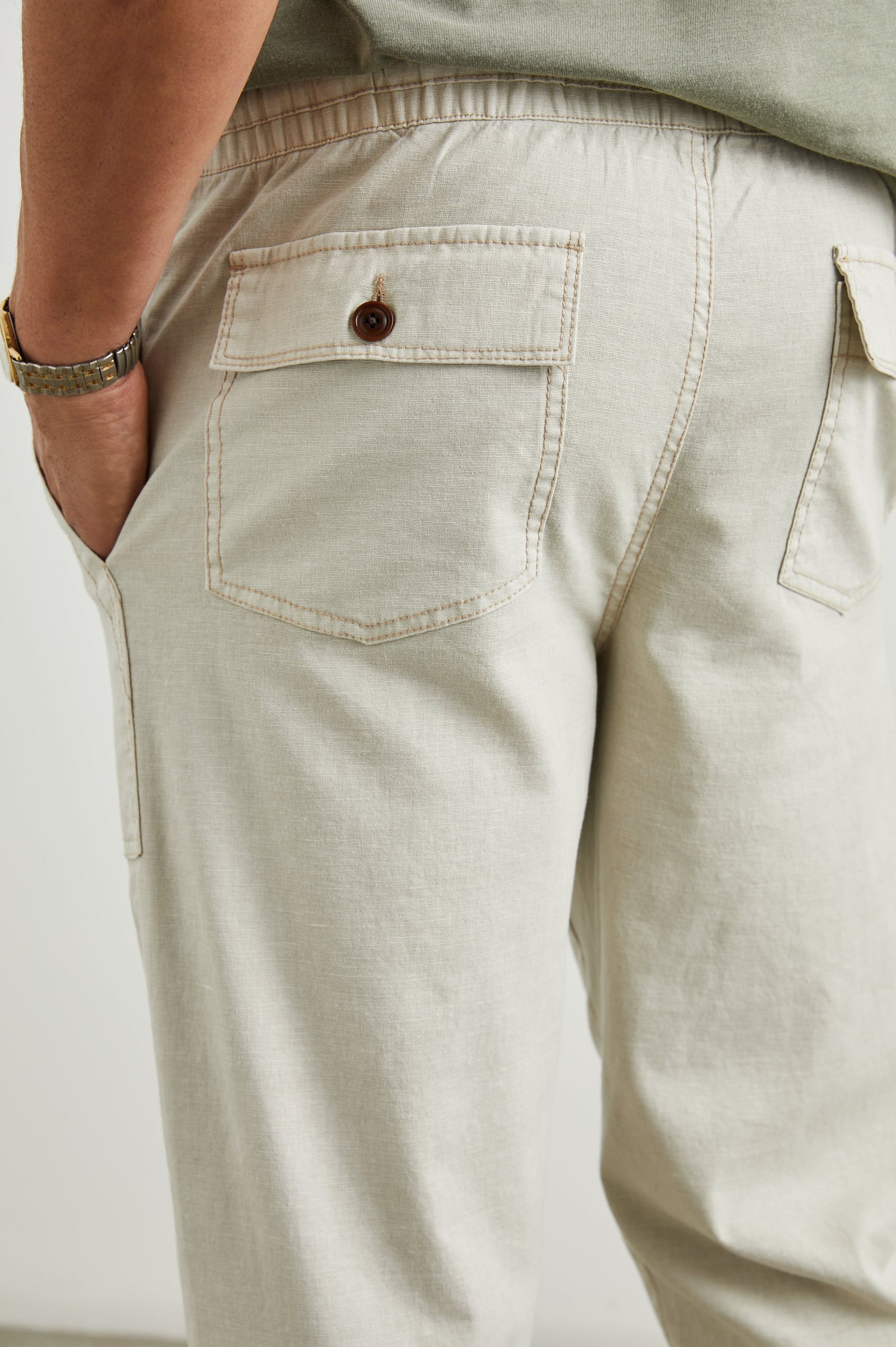 Gobi Pants with Drawstring Waist, Two Large Front Pockets and Two Back Buttoned Patch Pockets in Natural Colorway - Back View Featured on Model