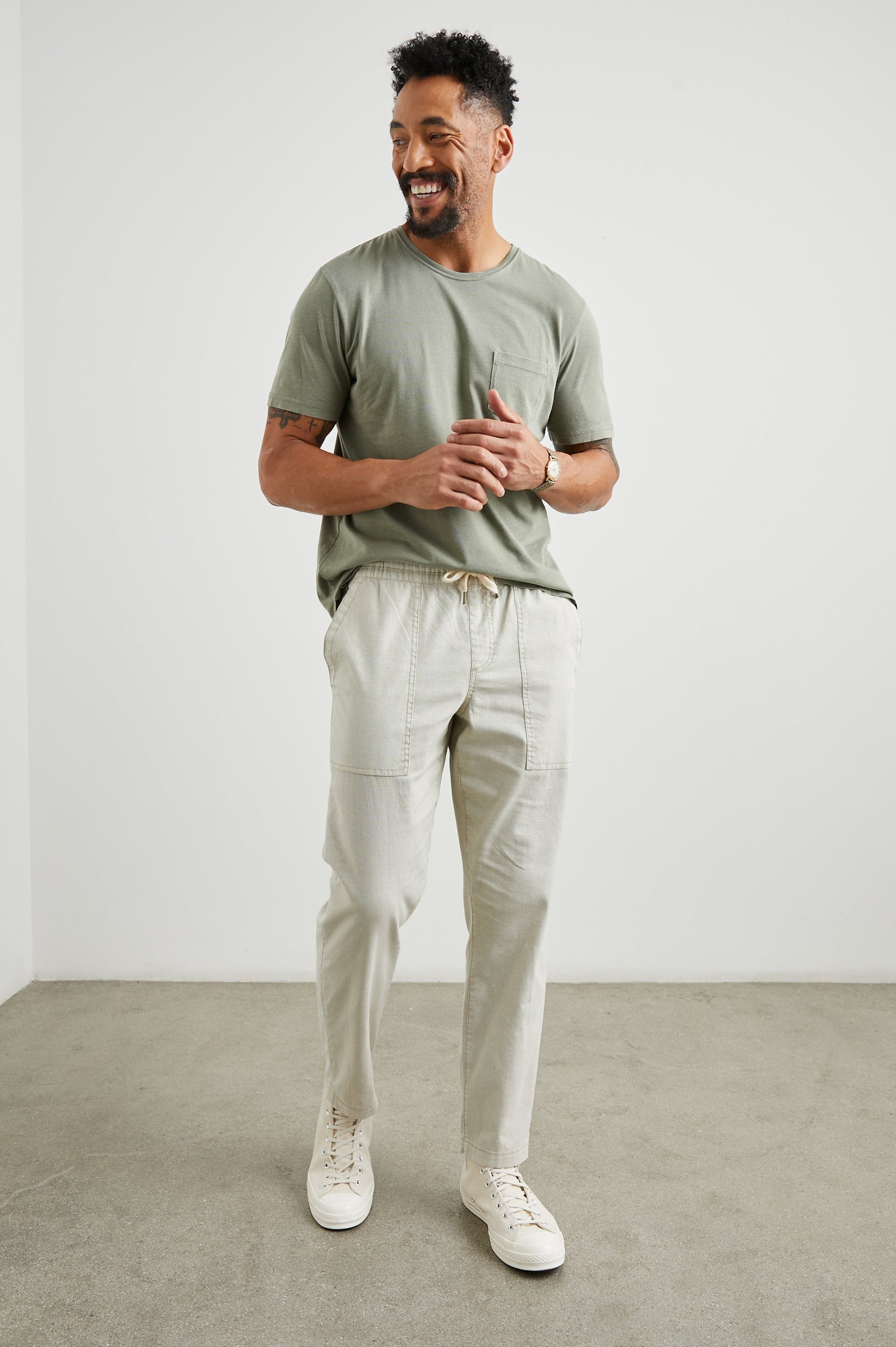 Gobi Pants with Drawstring Waist, Two Large Front Pockets and Two Back Buttoned Patch Pockets in Natural Colorway - Front Full Body View Featured on Model