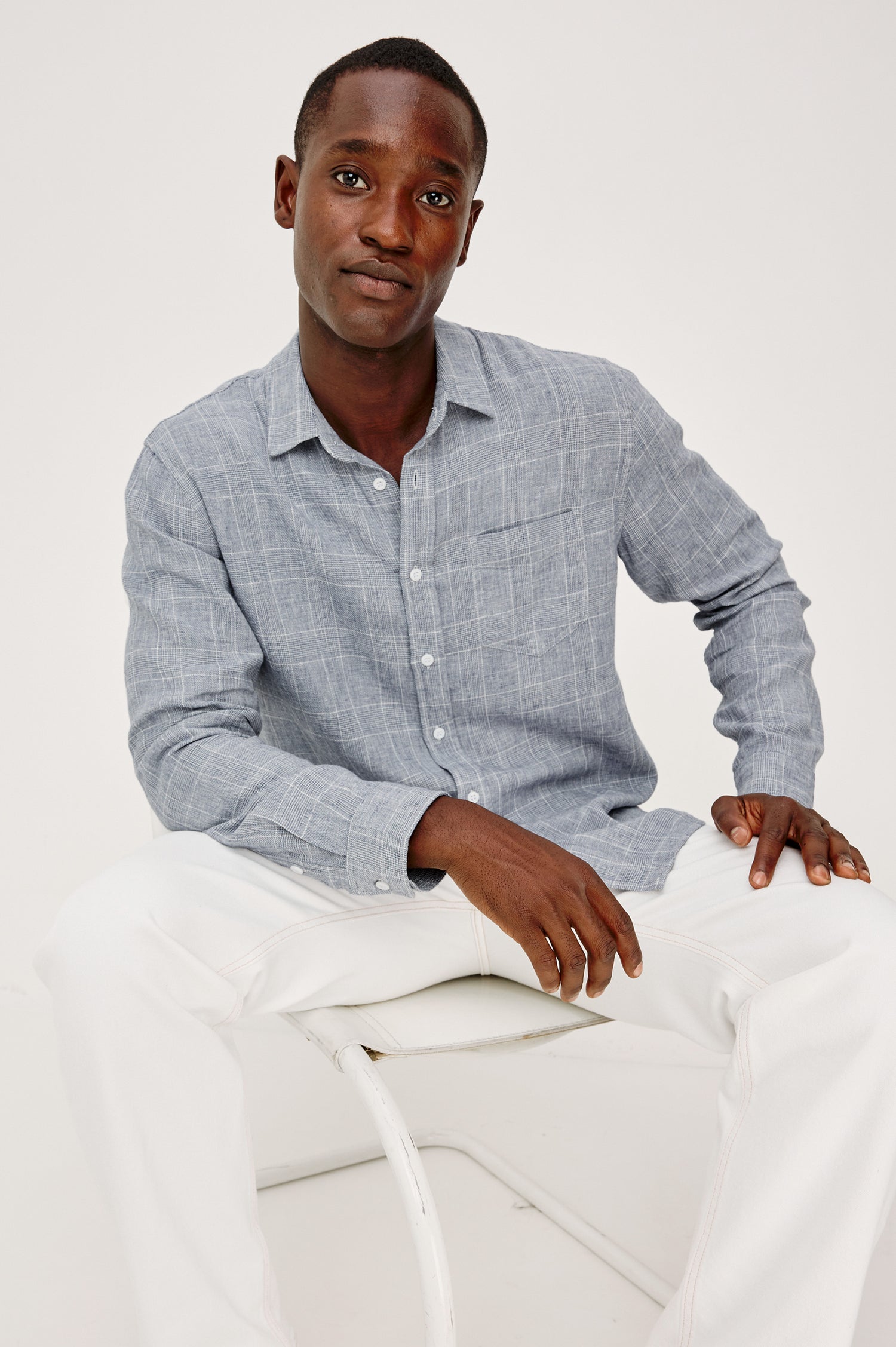 Gracy Collared Button Front Shirt in Linen Cotton Blend With Chest Patch Pocket and Long Sleeves in Navy White Colorway - Upper Body Front View Featured on Model Sitting