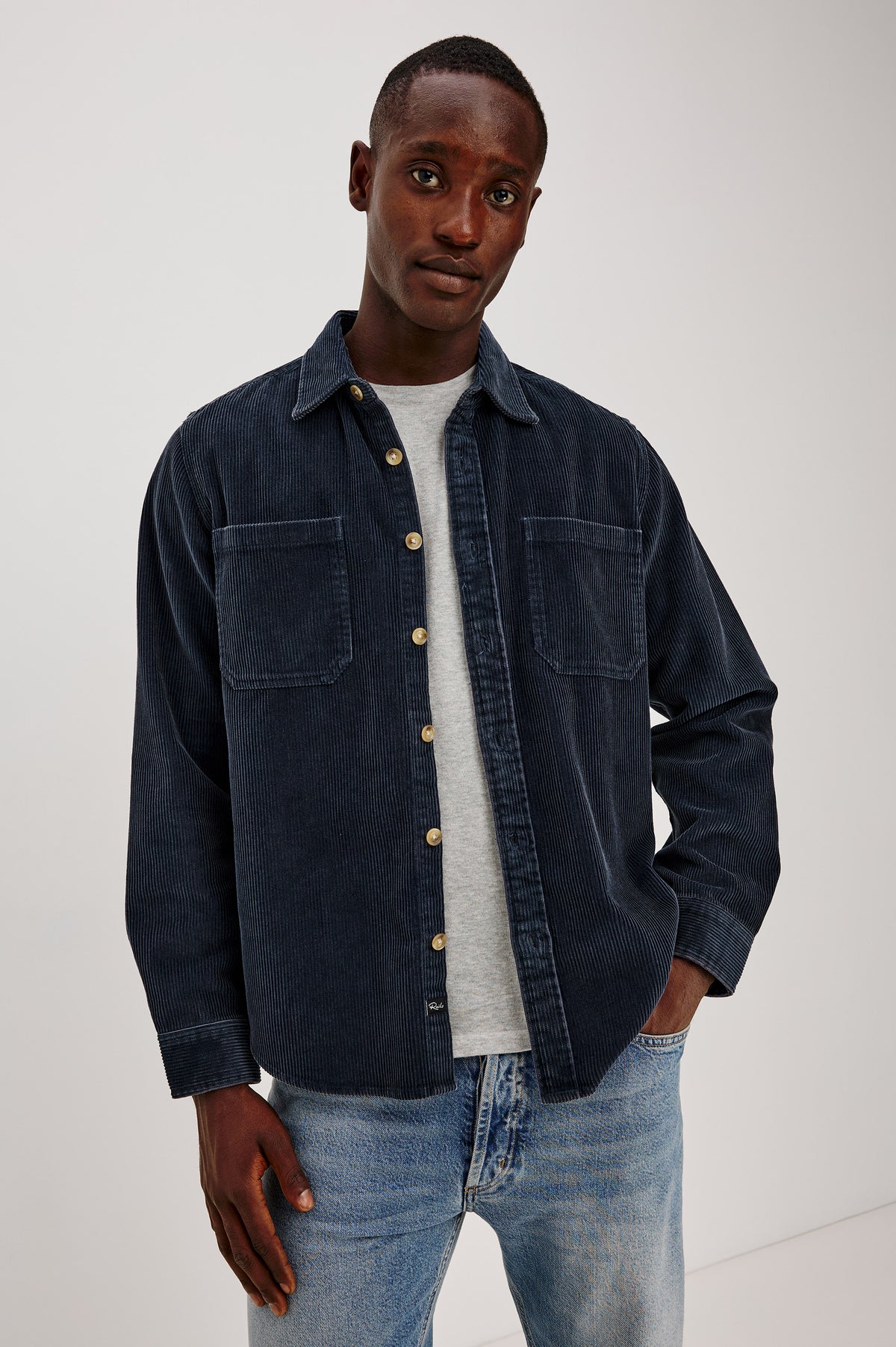 Graham Overshirt in Corduroy With Vintage Wash, Relaxed Fit, Collar, Chest Patch Pocket, and Front Buttons in Midnight Blue Colorway - Upper Body Front View Featured on Model