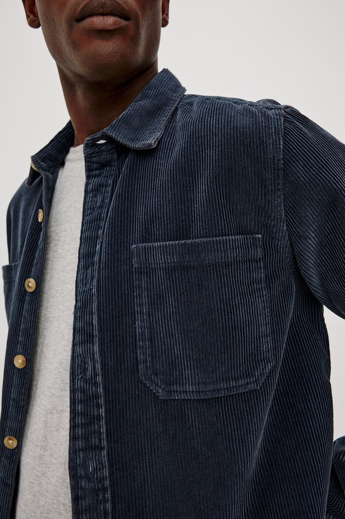 Graham Overshirt in Corduroy With Vintage Wash, Relaxed Fit, Collar, Chest Patch Pocket, and Front Buttons in Midnight Blue Colorway - Upper Body Close Up View Featured on Model