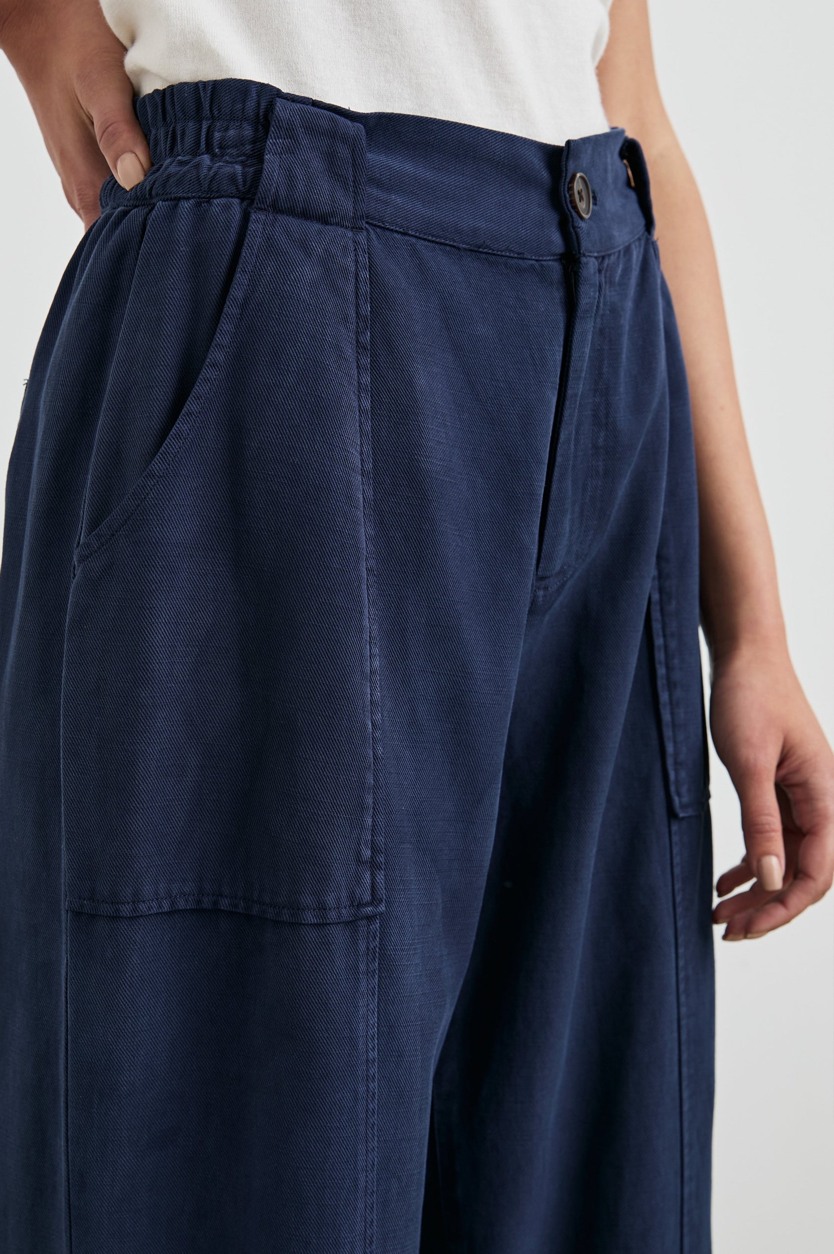 Greer Pants with Two Large Front Pockets, Two Back Welt Pockets and Vertical Seams Down the Front and Back Legs in Navy Colorway - Front View Featured on Model 
