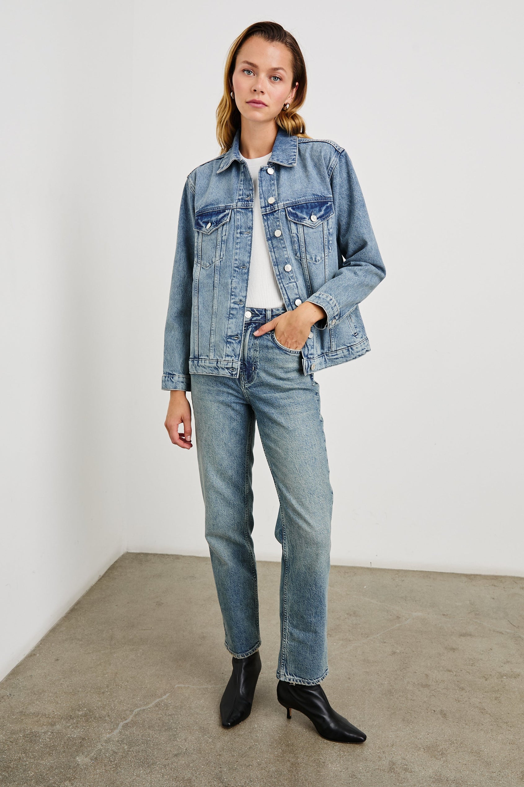 Grove Boyfriend Trucker Denim Jacket with Button Closure, Two Front Pockets, Two Chest Button Flap Pockets, Front Vertical Seams in Embossed Indigo Colorway - Front Full Body View Featured on Model  