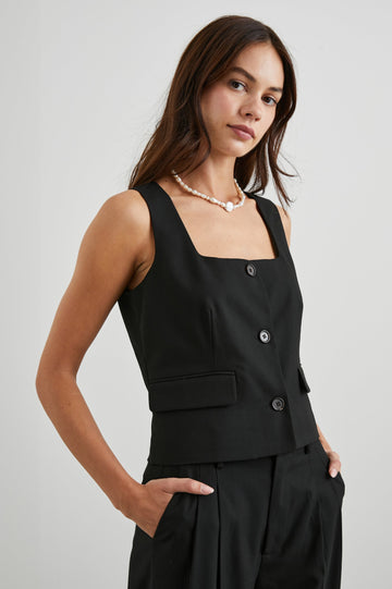 Guilia Cropped Vest with a Square Neckline, Button Closure and Two Front Flap Pockets in Black Twill Colorway - Front View Featured on Model 