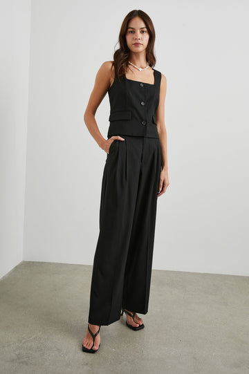 Guilia Cropped Vest with a Square Neckline, Button Closure and Two Front Flap Pockets in Black Twill Colorway - Front Full Body View Featured on Model 