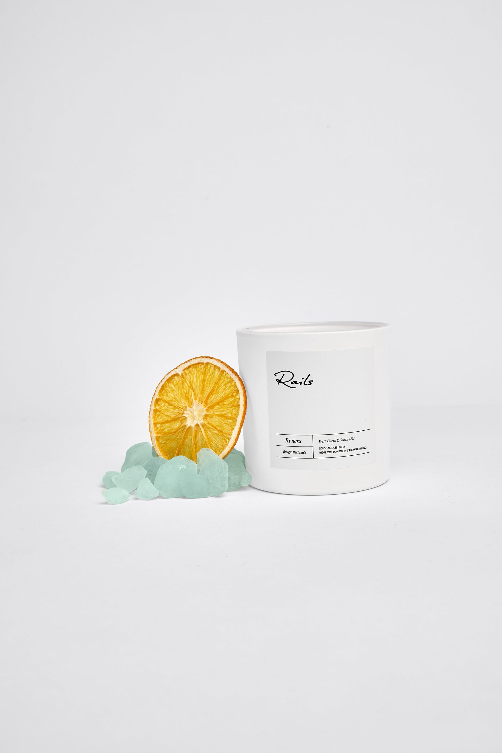Riviera 9 Ounce Candle in an Oval Container with a Box, Citrus and Ocean Mist - Featured with an Orange and Beach Rocks
