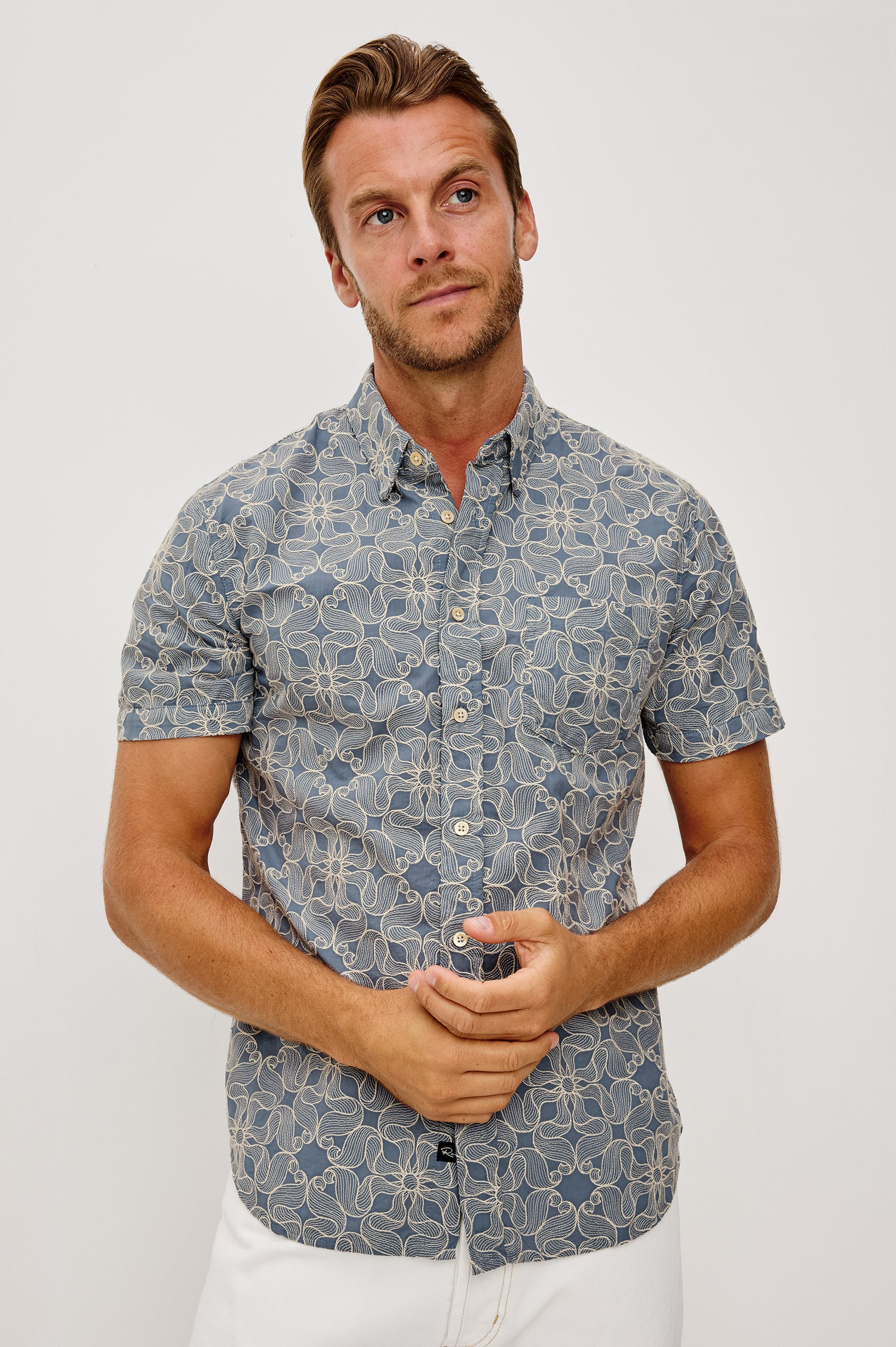 Hale Button-Up Short Sleeve Shirt in Lightweight Cotton With Contrast Jute Floral Embroidery and a Classic Fit in Daisy Steel Colorway - Upper Body Front View Featured on Model