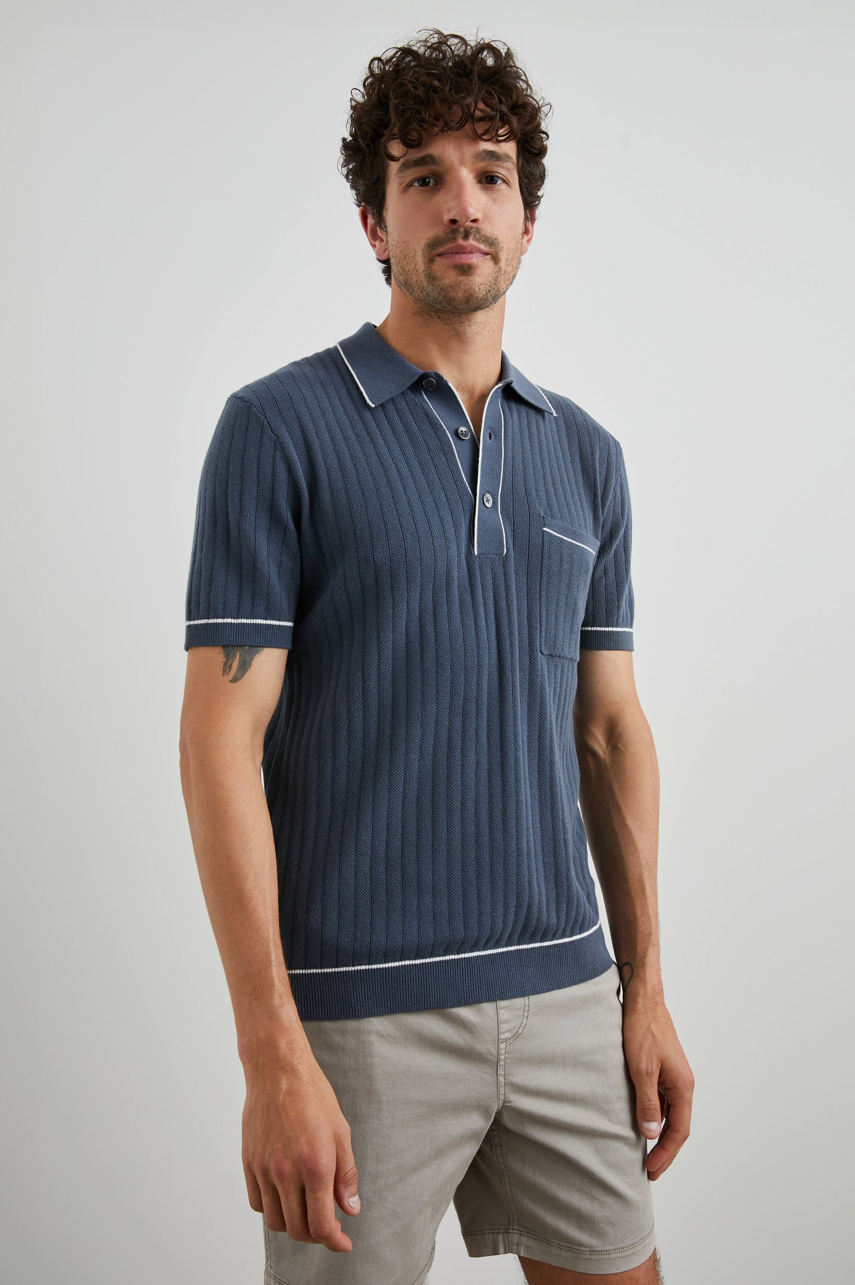 Hardy Short-Sleeve Ribbed Polo Shirt with a Chest Patch Pocket and a Three-Button Placket in Faded Navy Colorway, with White Trim - Front View Featured on Model 