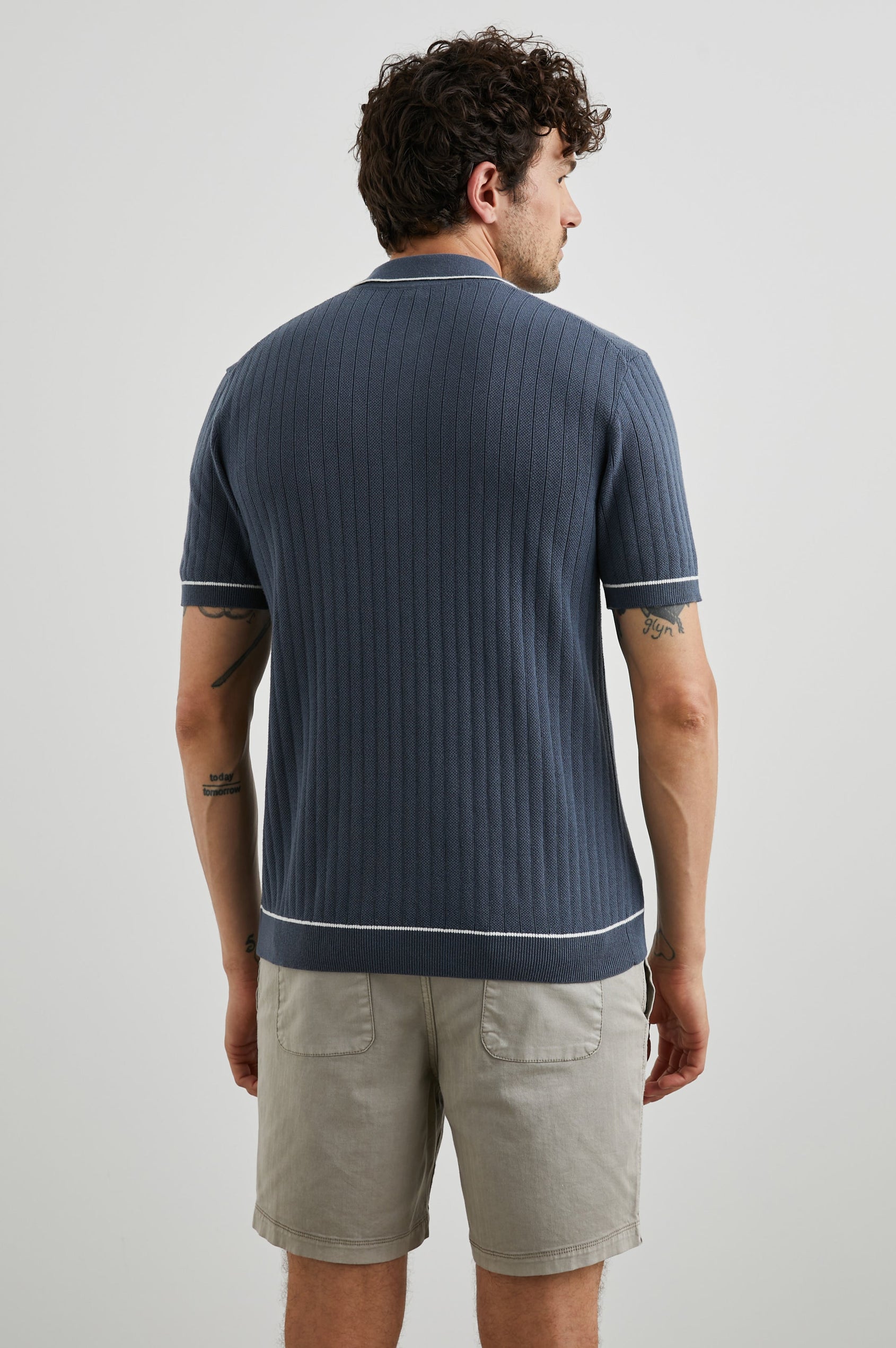 Hardy Short-Sleeve Ribbed Polo Shirt with a Chest Patch Pocket and a Three-Button Placket in Faded Navy Colorway, with White Trim - Back View Featured on Model 