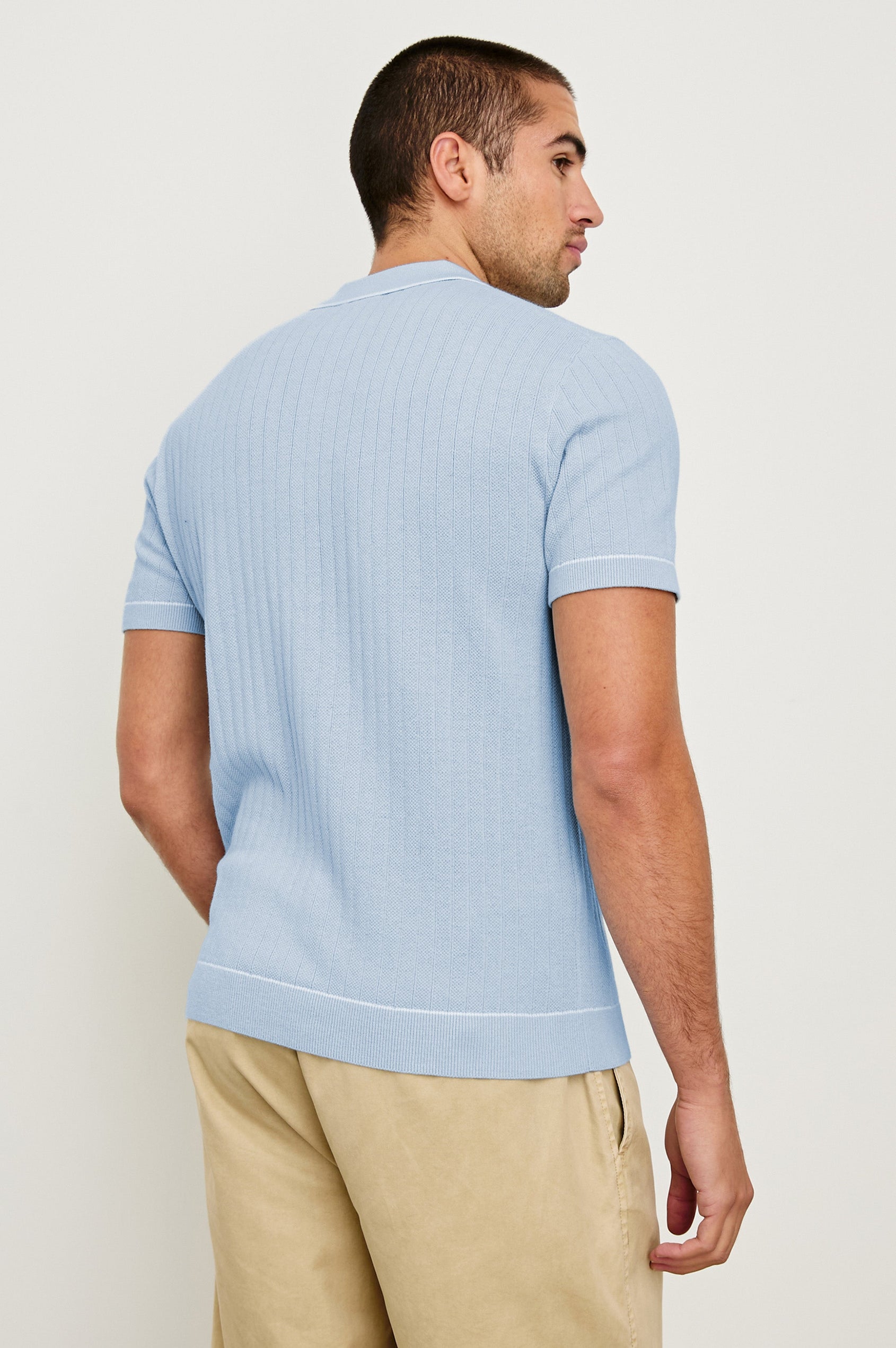 Hardy short sleeve cotton rib polo with chest pocket, two button placket and contrast stitching in Light Blue Melange - back view on model