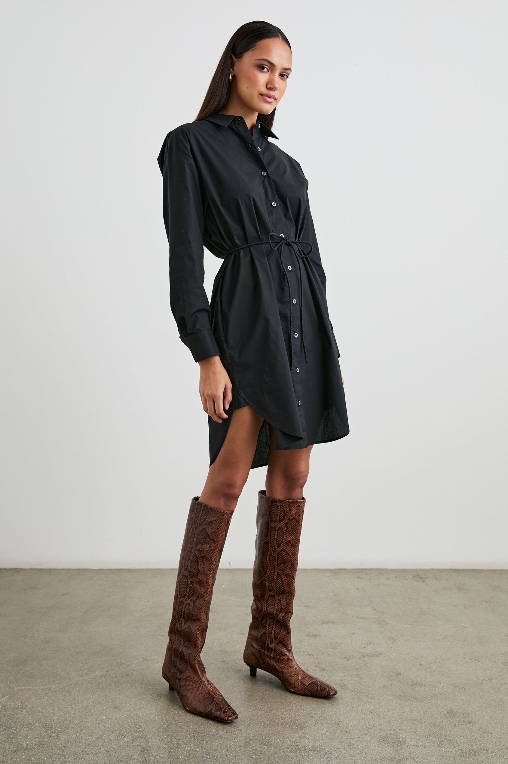 Harmony Long-Sleeve Mini Dress with Buttons Down the Front, Buttoned Cuffs, a Collar, Side Slits and a Tie at the Waist in Black Colorway - Front Full Body View Featured on Model