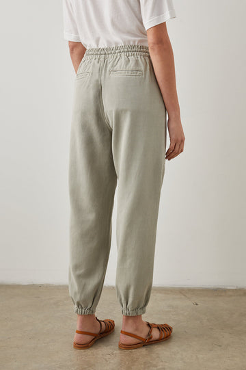 Haven Pants with a Drawstring Waist, Front Seams, Elasticized Hems, Two Front Pockets and Two Back Welt Pockets in Sage Colorway - Back View Featured on Model 