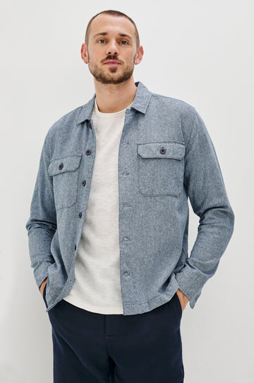 Hayes Shirt Jacket with Long Sleeves and Chest Flap Pockets with Button Closure, Exposed Button Front in Blue Mirage. Front View Shown on Model.