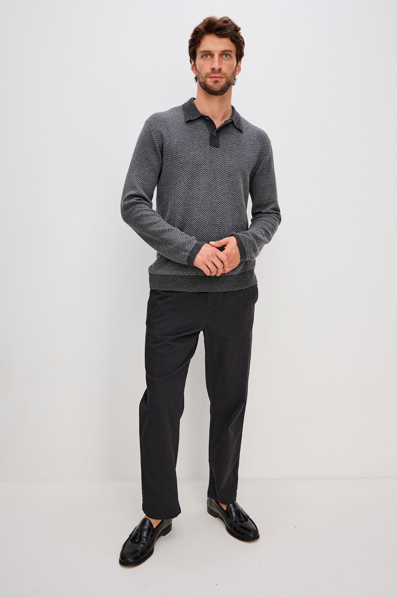 Herrington Long-Sleeve Collared Sweater with a Two Button Placket and a Herringbone Jacquard in Charcoal Herringbone Melange Colorway. Front Full Body View Featured on Model.