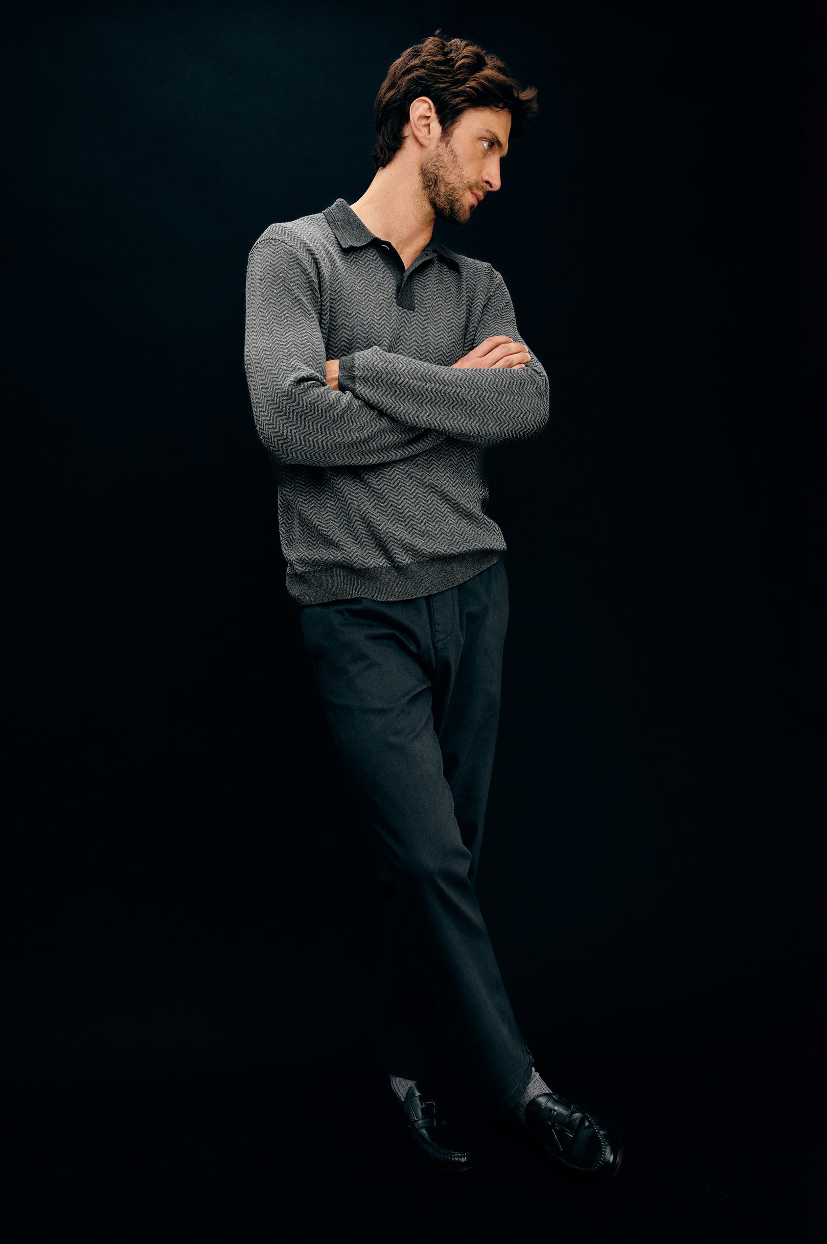 Herrington Long-Sleeve Collared Sweater with a Two Button Placket and a Herringbone Jacquard in Charcoal Herringbone Melange Colorway. Front Full Body View Featured on Model.