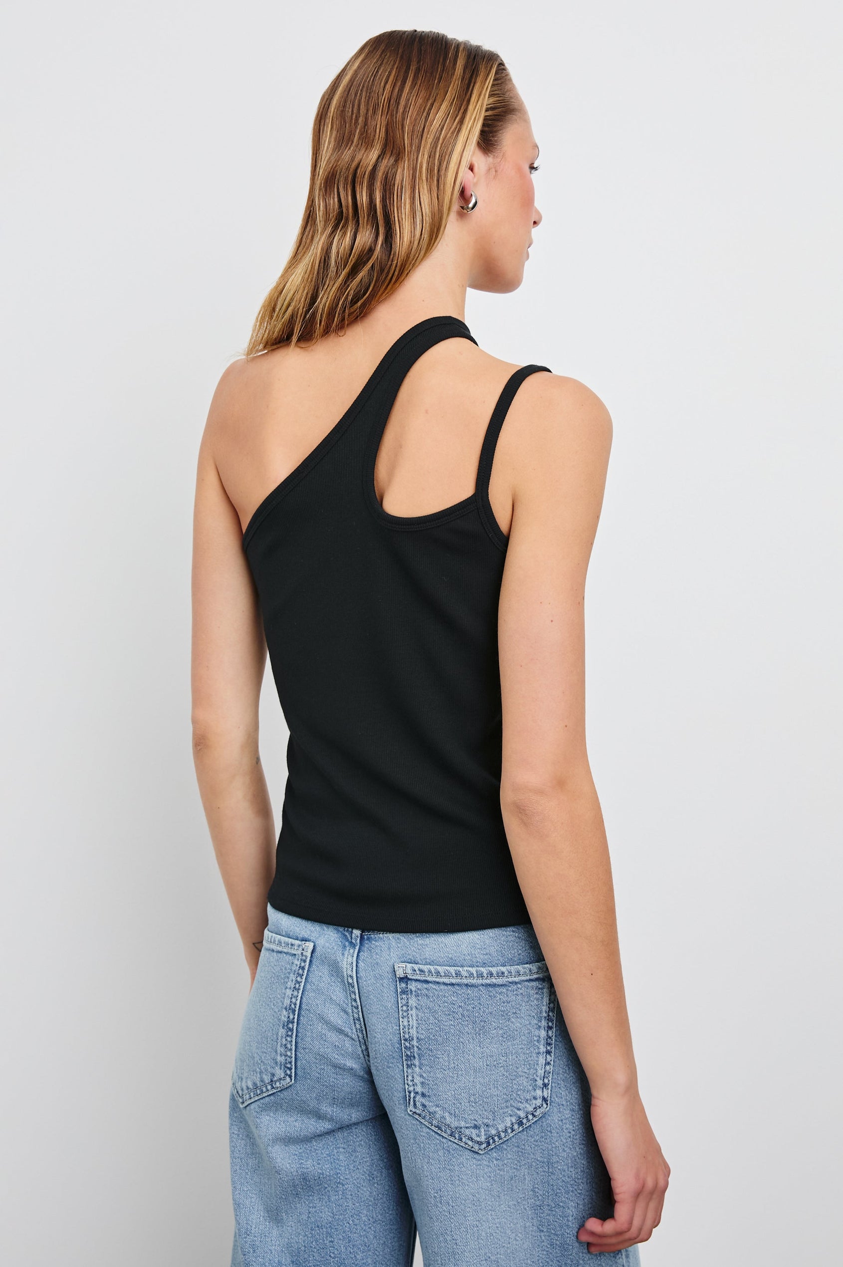Hira asymmetrical tank top with keyhole sleeve feature in Black - back view on model