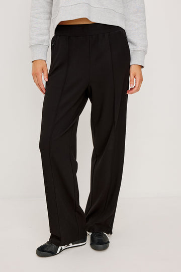 Black ponte pull-on pants with an elastic waistband. The pants feature functional ankle zippers that can be opened to create a subtle flare. Front View on Model.