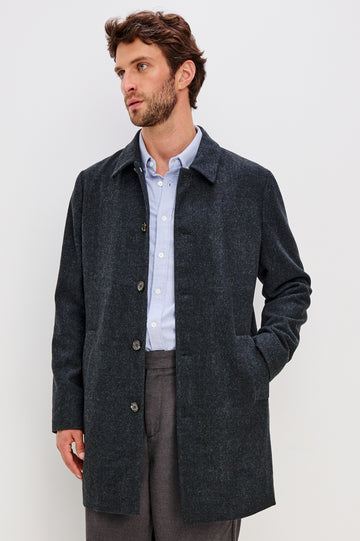 Hockney is a traditional top coat, wool-blended and lined with welt pockets, interior pockets on both sides (invisible zipper and welt), and a back vent, in Celestial Tweed Color. Front view featured on model.