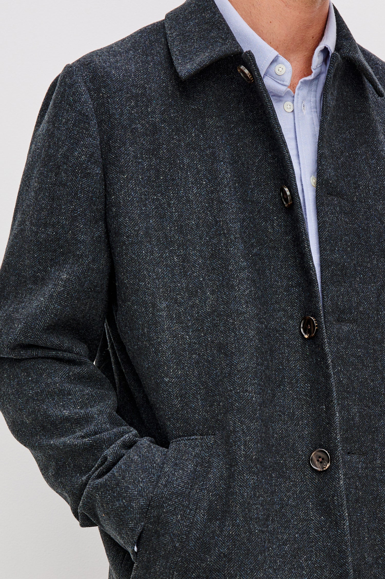 Hockney is a traditional top coat, wool-blended and lined with welt pockets, interior pockets on both sides (invisible zipper and welt), and a back vent, in Celestial Tweed Color. Front detailed view featured on model.