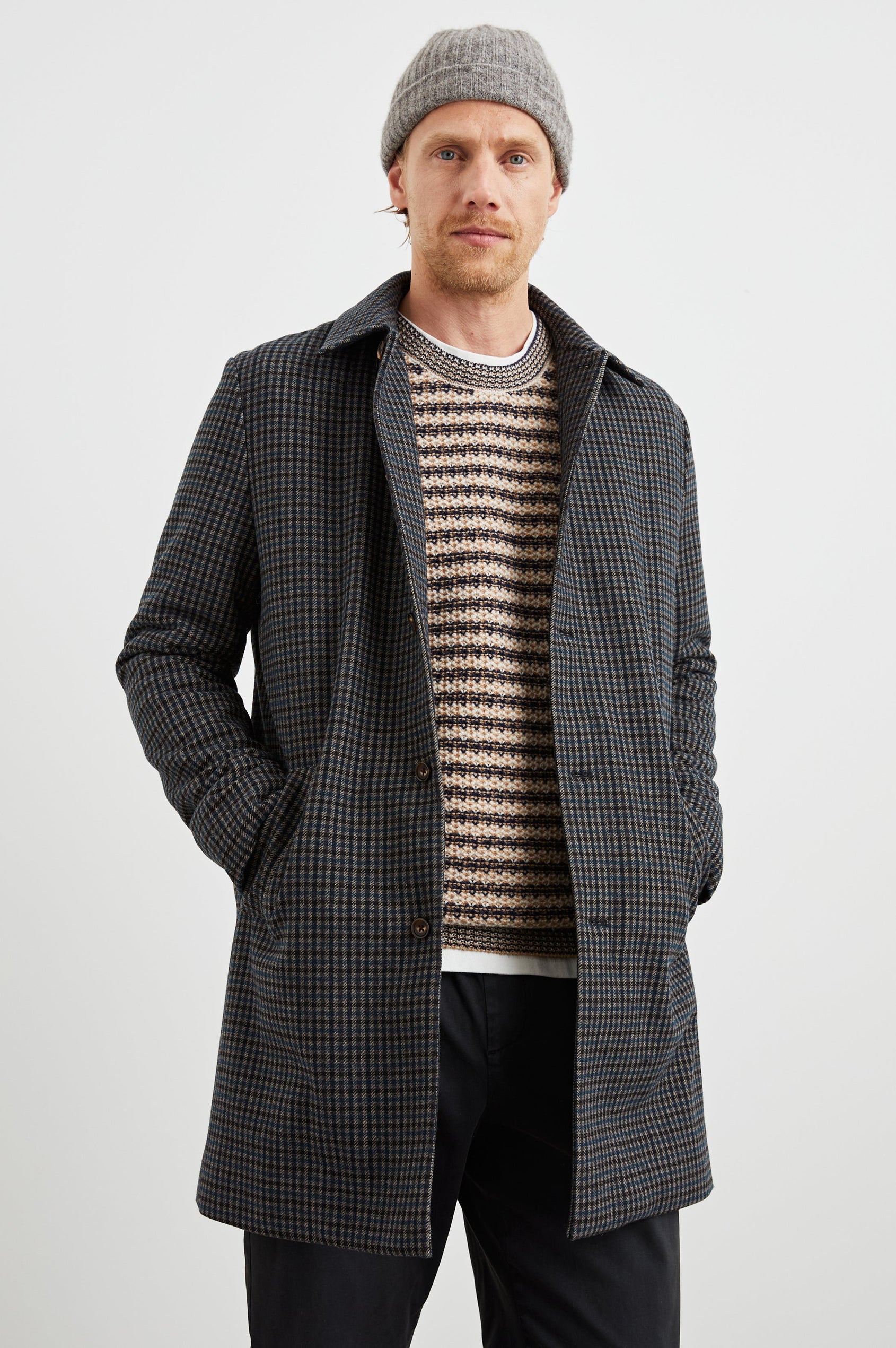 Hockney Mid-Thigh Length Overcoat with Button Closure, Two Front Pockets, and a Back Vent in Grey Check Plaid Colorway, a plaid in Grey, Black and Blue - Front View Featured on Model