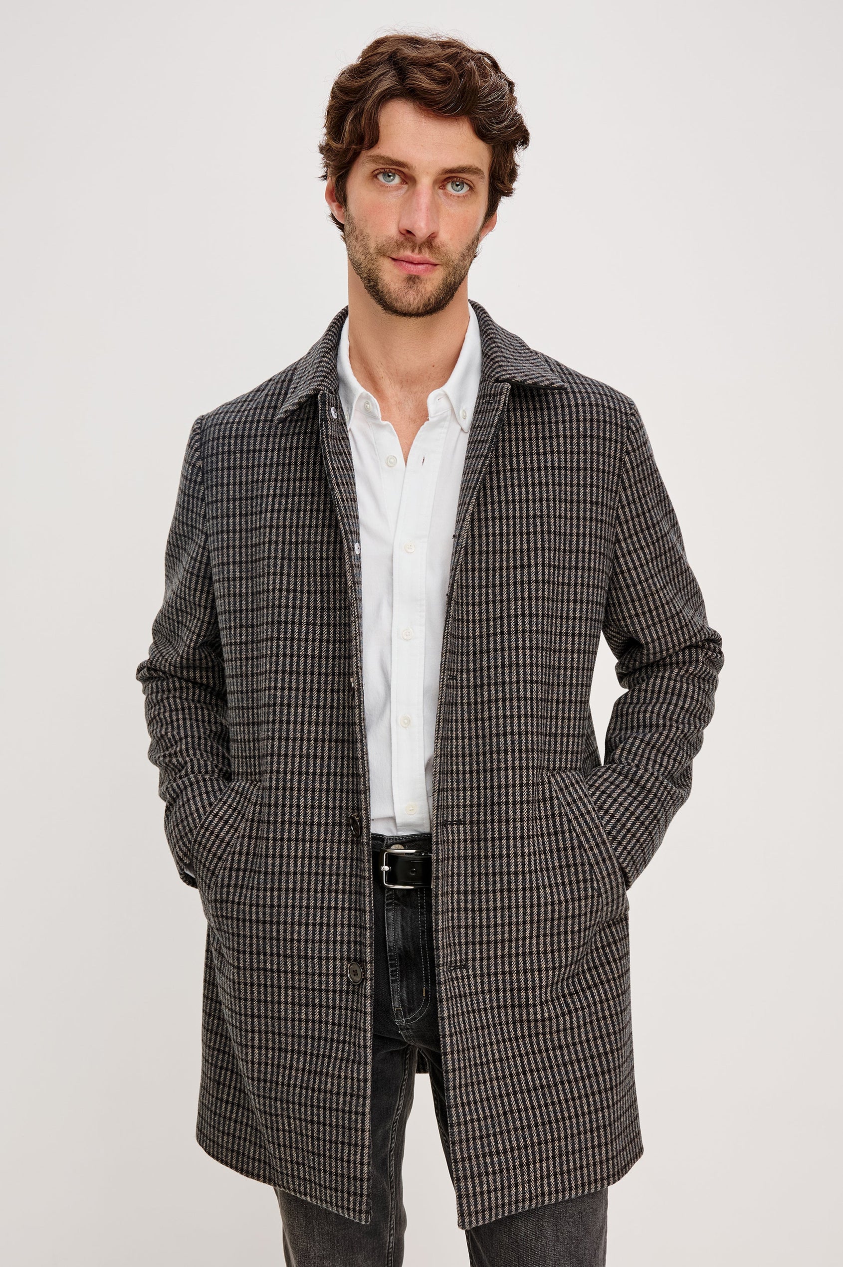Hockney Mid-Thigh Length Overcoat with Button Closure, Two Front Pockets, and a Back Vent in Grey Check Plaid Colorway, a plaid in Grey, Black and Blue - Front View Featured on Model
