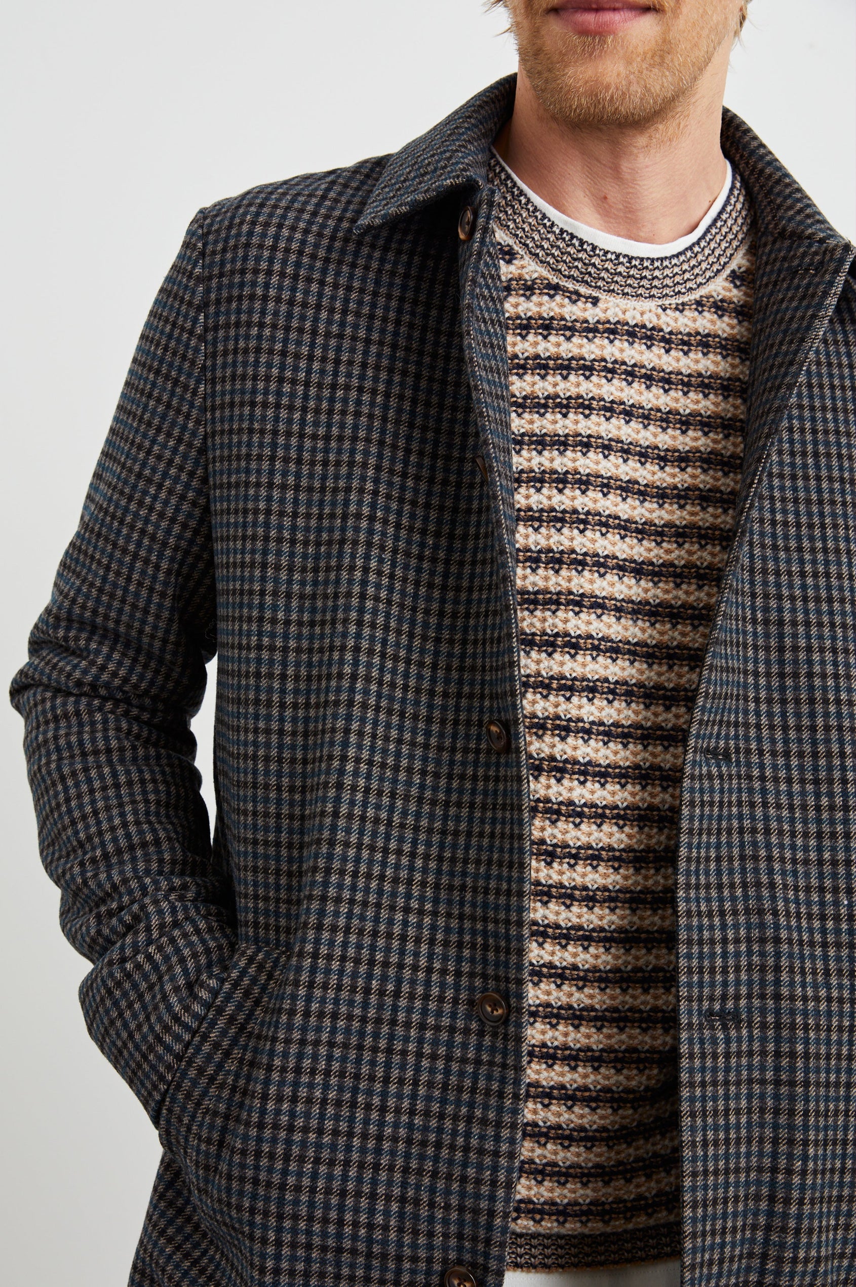 Hockney Mid-Thigh Length Overcoat with Button Closure, Two Front Pockets, and a Back Vent in Grey Check Plaid Colorway, a plaid in Grey, Black and Blue - Front View Featured on Model