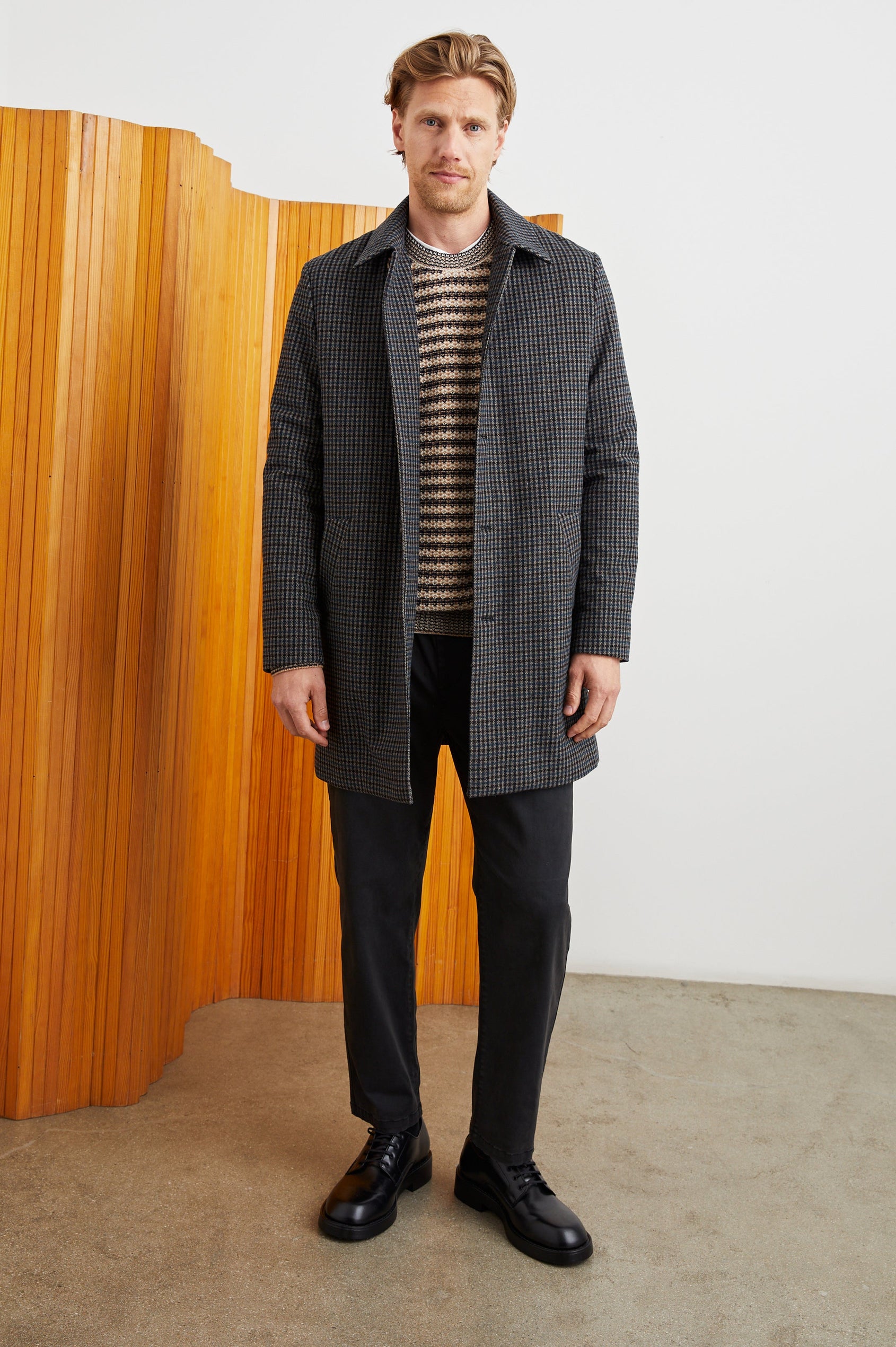 Hockney Mid-Thigh Length Overcoat with Button Closure, Two Front Pockets, and a Back Vent in Grey Check Plaid Colorway, a plaid in Grey, Black and Blue - Front Full Body View Featured on Model