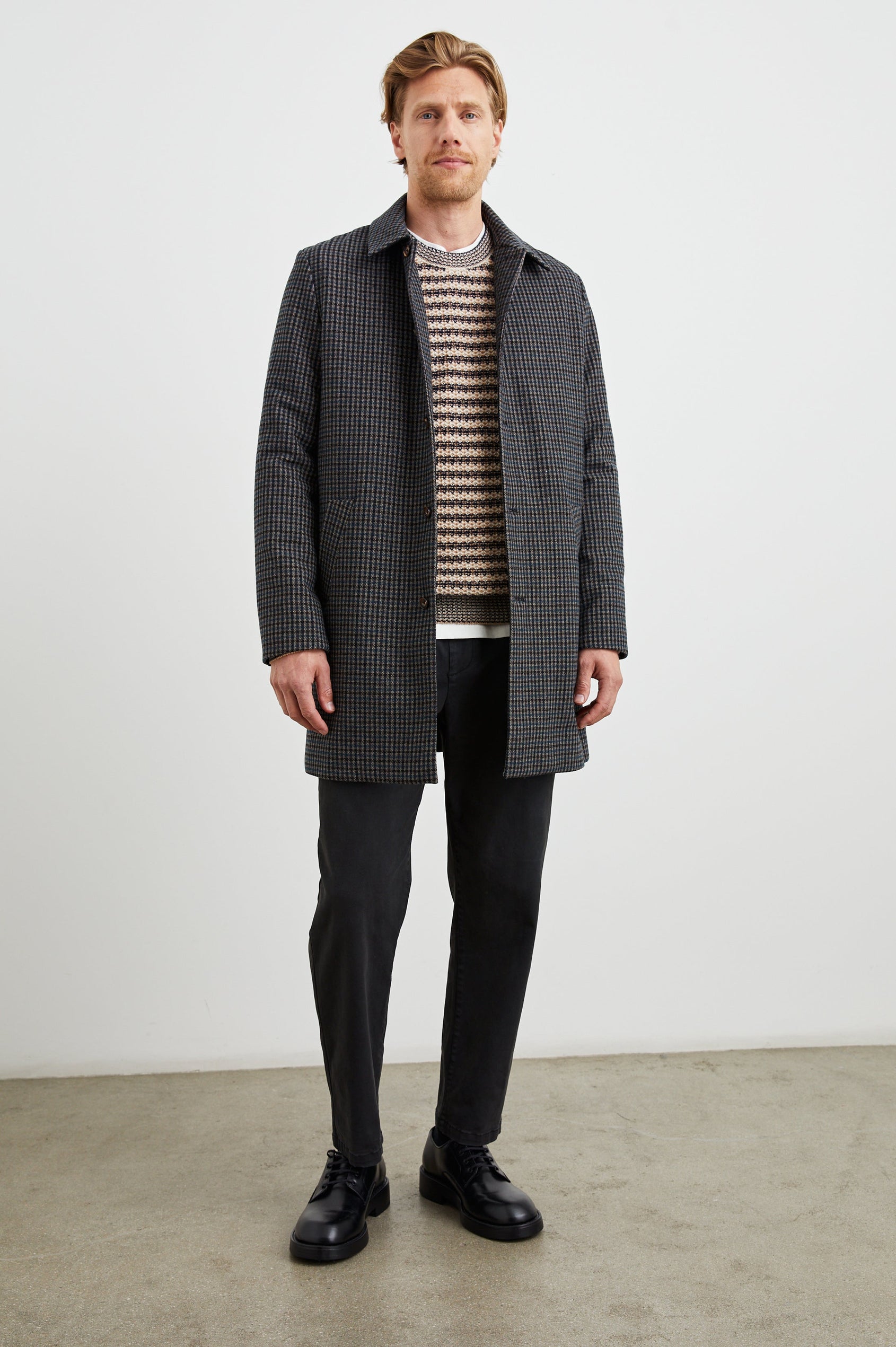 Hockney Mid-Thigh Length Overcoat with Button Closure, Two Front Pockets, and a Back Vent in Grey Check Plaid Colorway, a plaid in Grey, Black and Blue - Front Full Body View Featured on Model