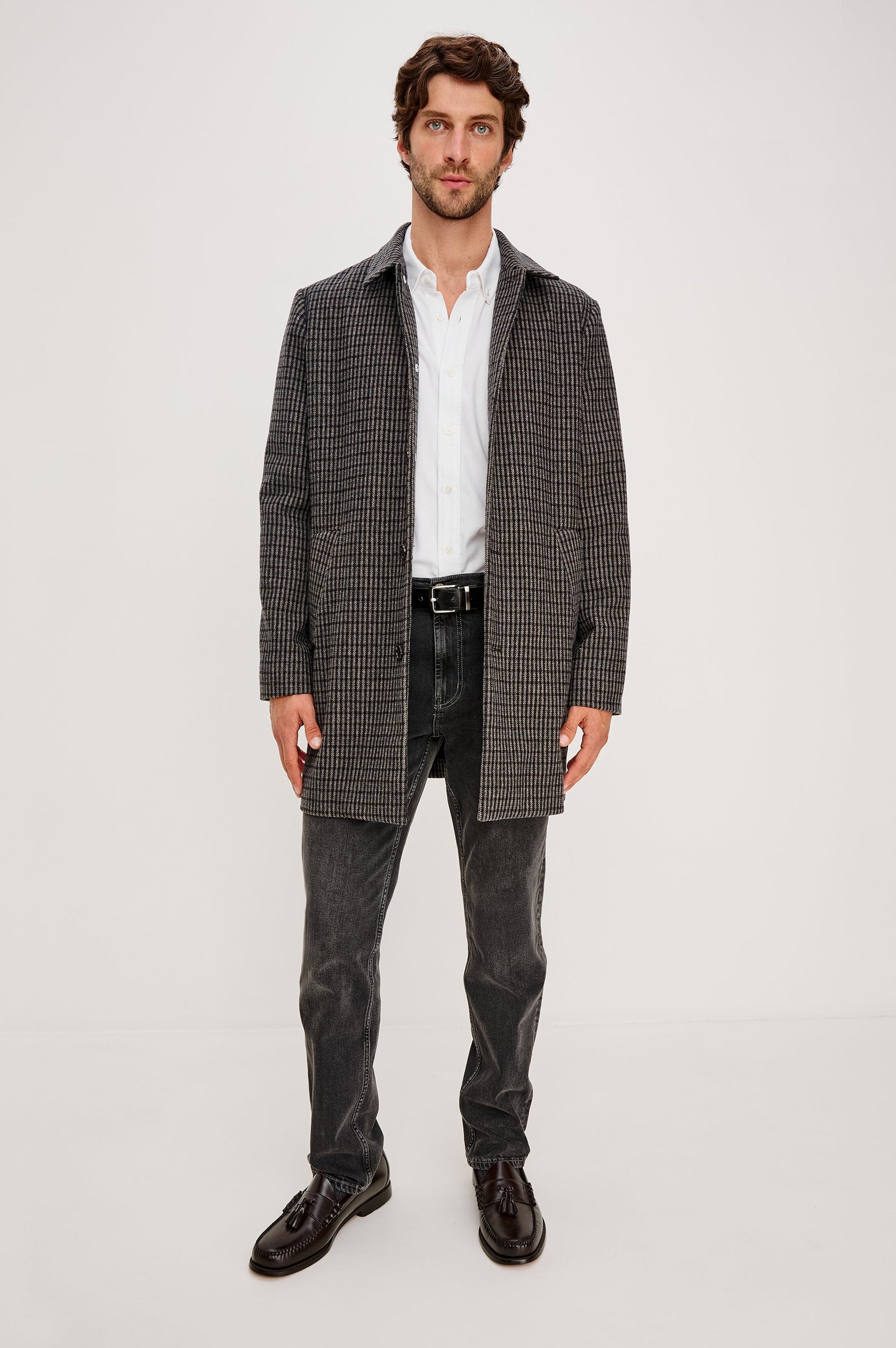Hockney Mid-Thigh Length Overcoat with Button Closure, Two Front Pockets, and a Back Vent in Grey Check Plaid Colorway, a plaid in Grey, Black and Blue - Front Full Body View Featured on Model