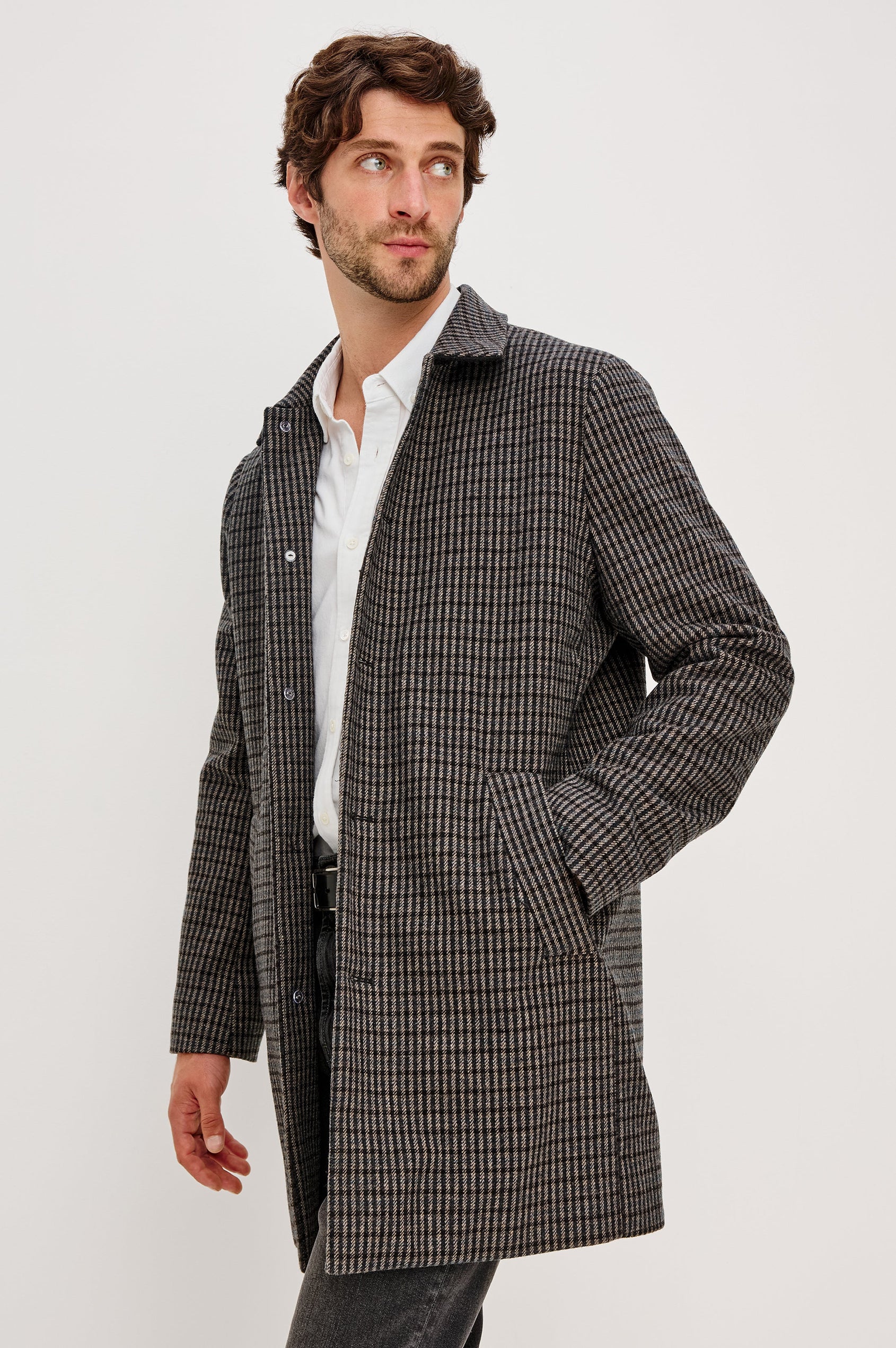 Hockney Mid-Thigh Length Overcoat with Button Closure, Two Front Pockets, and a Back Vent in Grey Check Plaid Colorway, a plaid in Grey, Black and Blue - Front side View Featured on Model