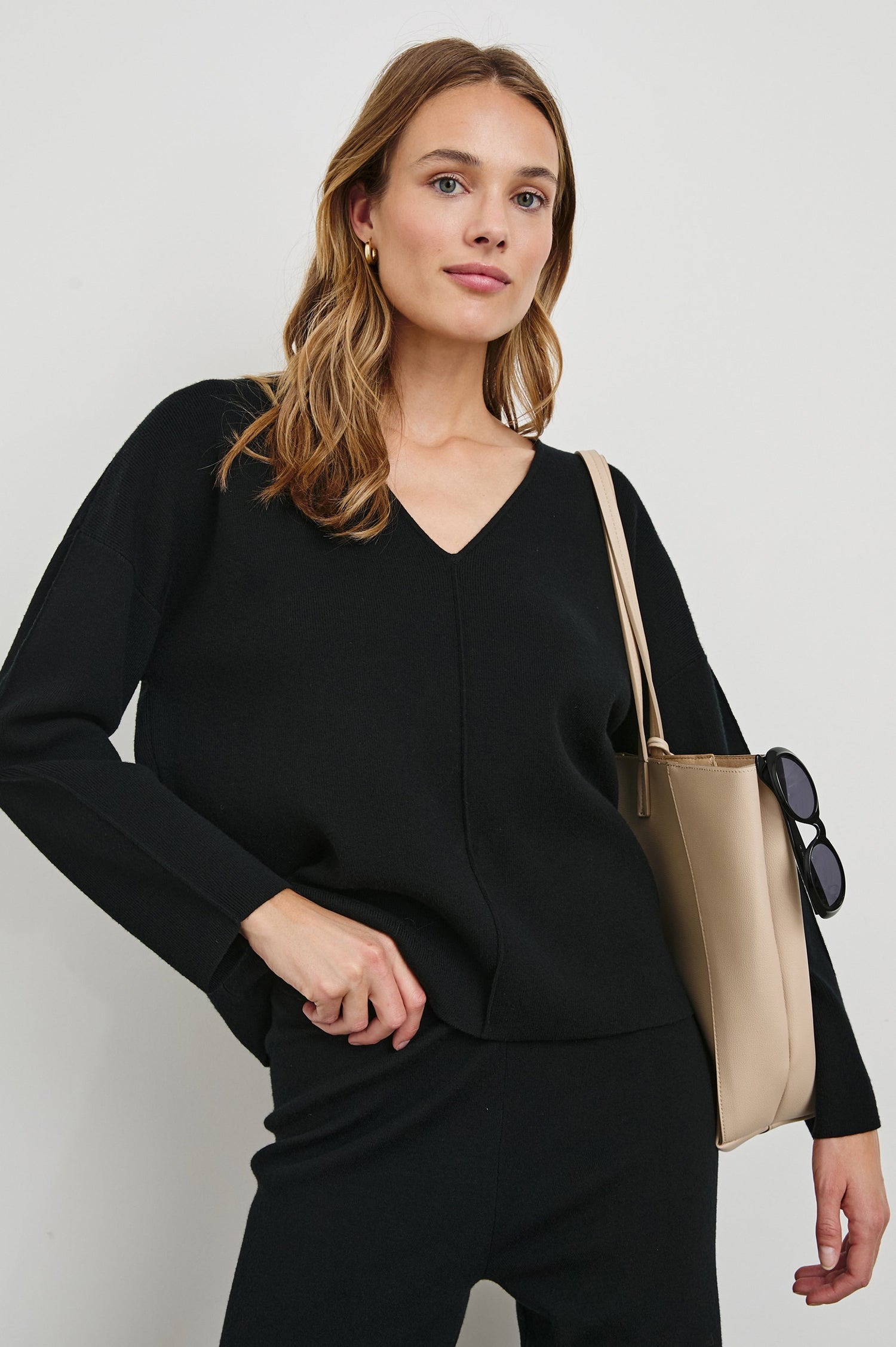 Hollyn Long-Sleeve Sweater with a V Neck and a Seam Down the Front Bodice and Sleeves in Black Colorway- Front View Featured on Model