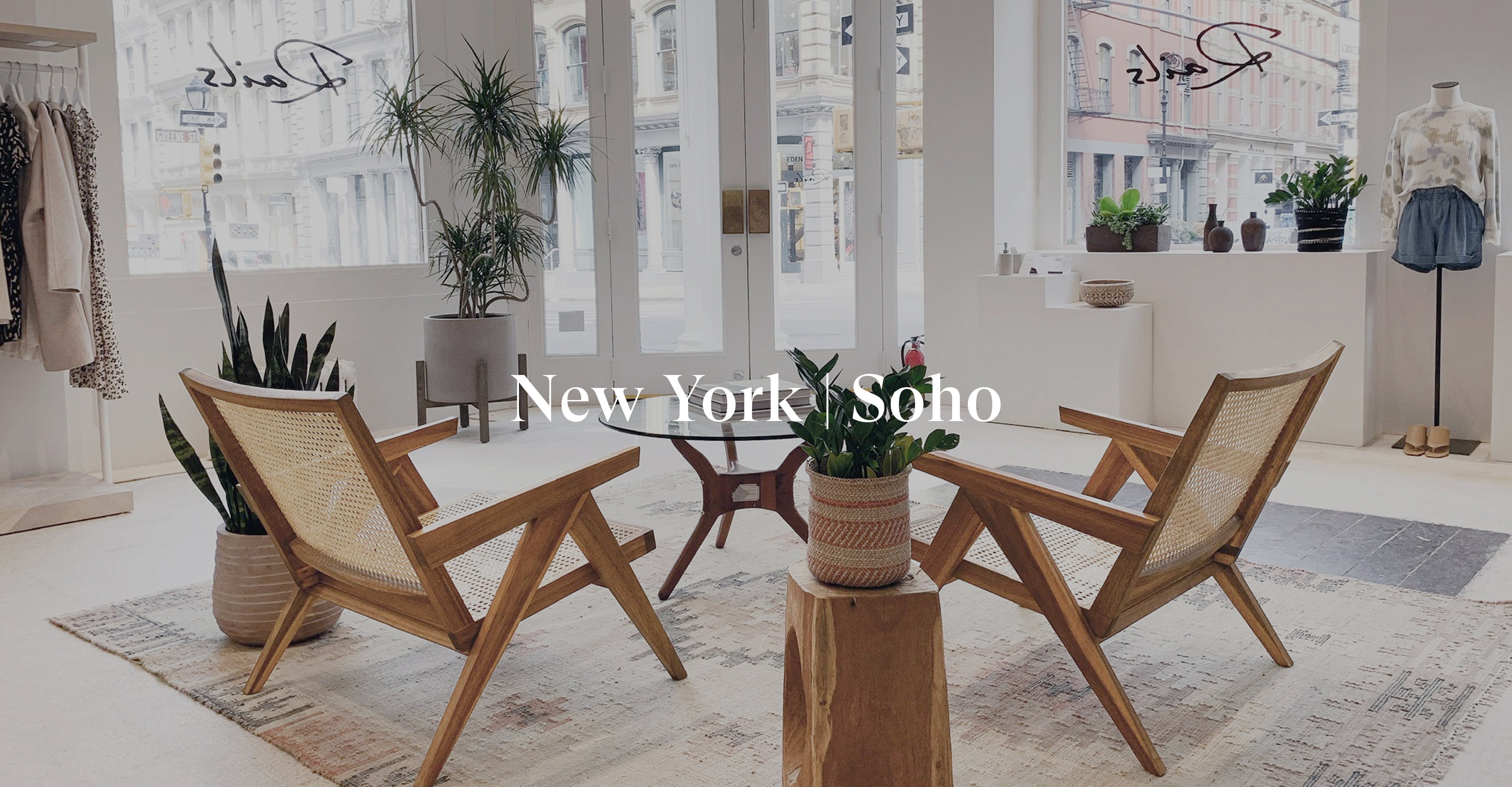 INSIDE OF SOHO STORE SHOWING THE ENTRANCE TO THE FRONT OF THE STORE AND TWO CHAIRS IN THE MIDDLE OF THE STORE