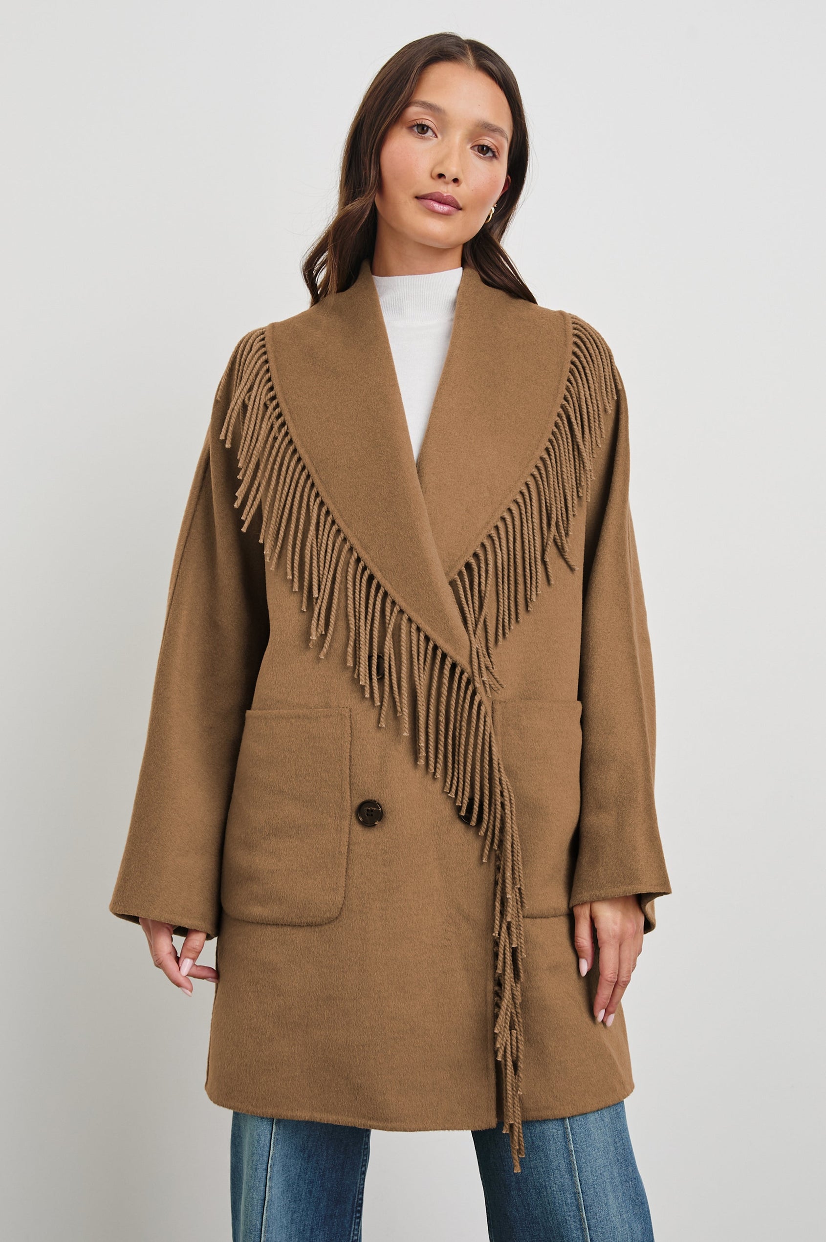 Hugo Double-Breasted, Mid-Thigh Length Coat with Button Closure, Wide Lapels, Two Front Patch Pockets and Fringe along the Lapels and Closure in Camel Colorway - Front View Featured on Model 