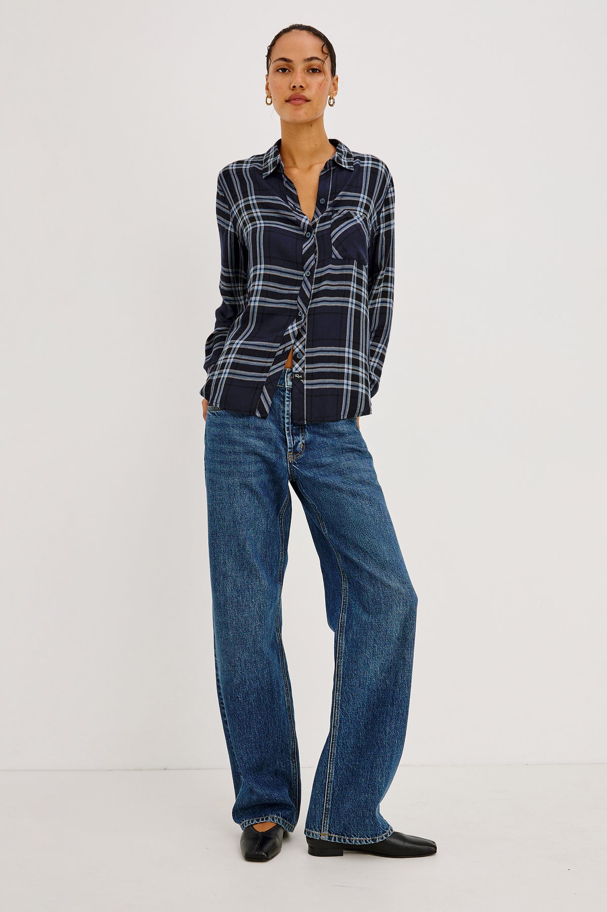 Hunter Shirt Plaid Button-Up With Relaxed Fit, Spread Collar, Chest Pocket, Long Sleeves, and Curved Hem in Indigo Sky Colorway - Side Crop View Featured on Model.