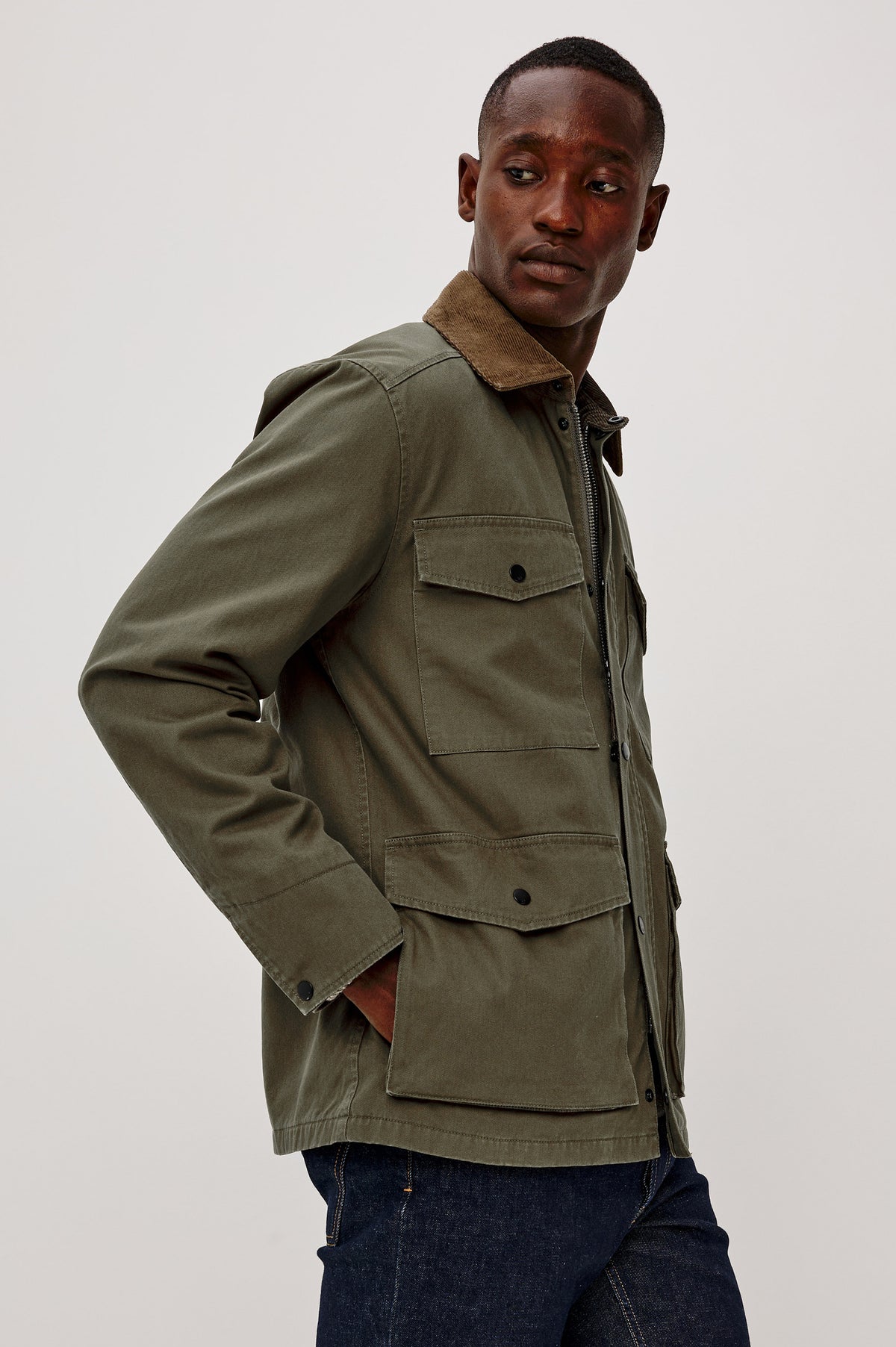 Huntly Jacket in Twill With Plaid Lining, Corduroy Collar, Storm Flap Snap-and-Zip, Four Front Snap Flap Pockets, and Long Sleeves in Highland Colorway - Upper Body Side View Featured on Model