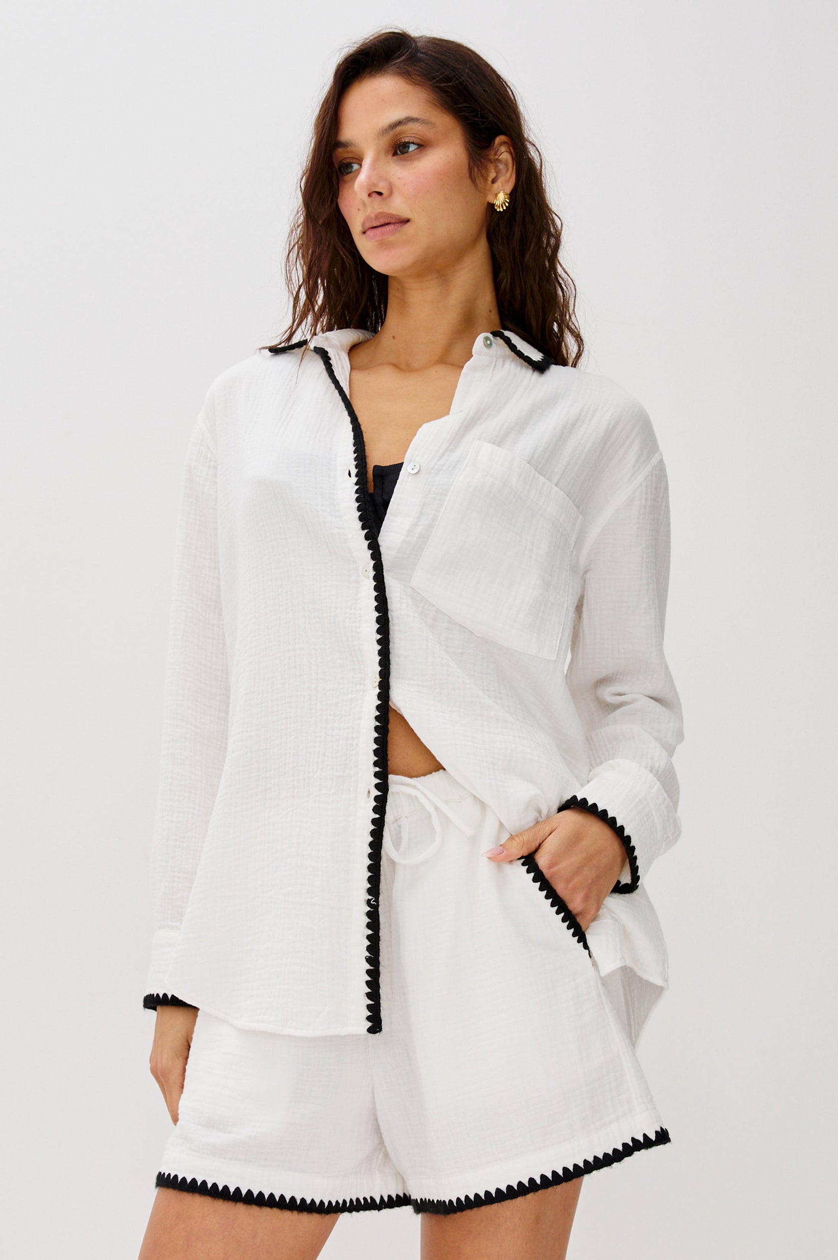 Idania Button Front Collared Shirt with Long Sleeves, Relaxed Fir and a Front Chest Pocket with a White Body in Black Blanket Stich Colorway. Front View Shown on Model Buttoned Up.