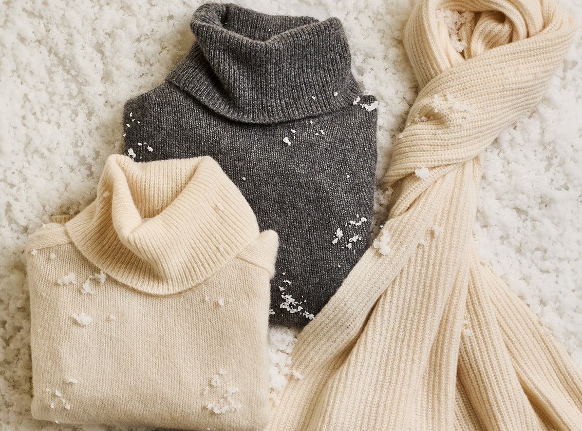 EDITORIAL IMAGE OF TWO SWEATERS AND A SCARF FOLDED