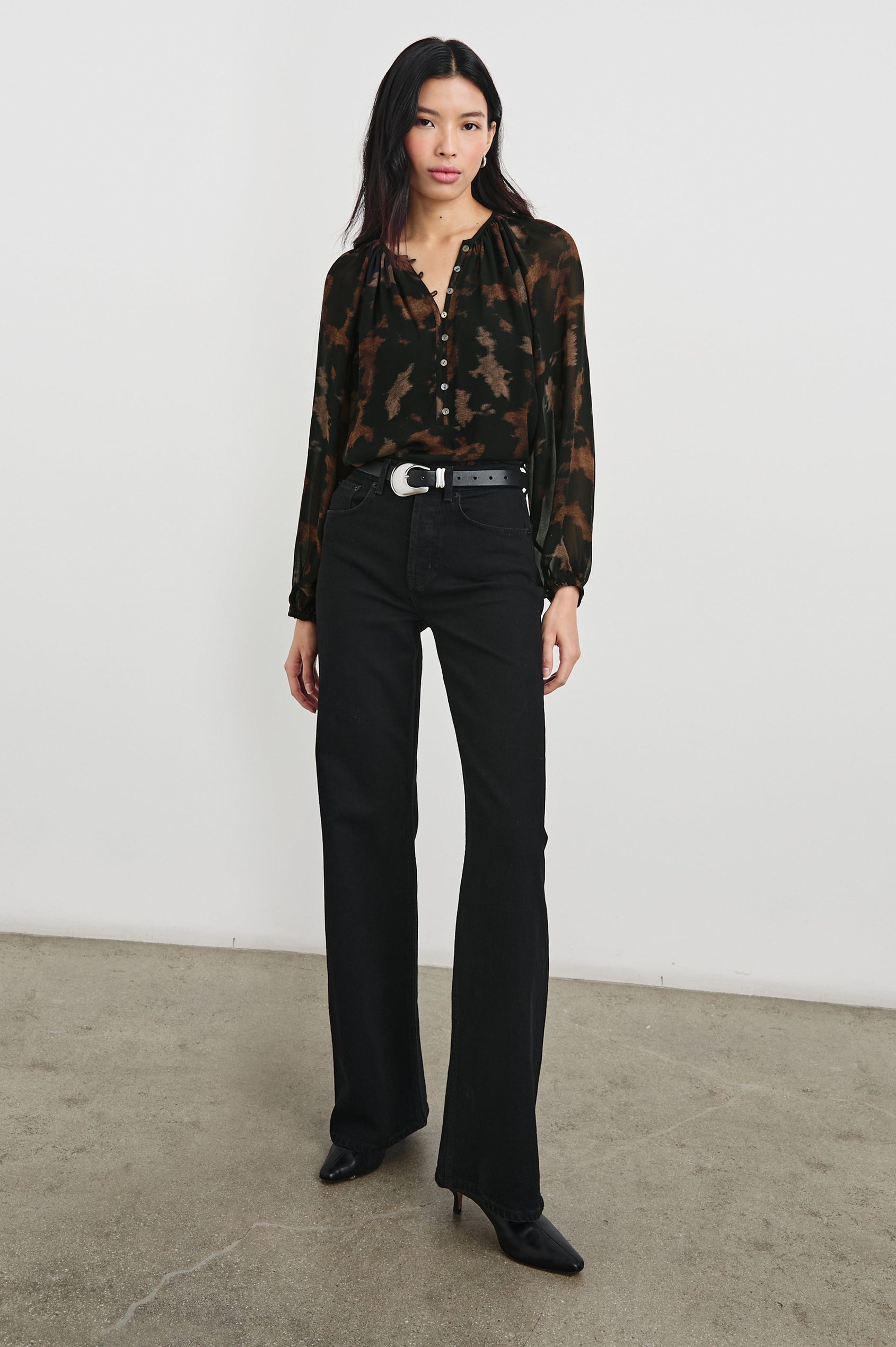 Indi Top with a V Neckline with a Button Placket, Pleating at Back Neckline and Elastic Cuffs in Diffused Sandstone Colorway, with black and browns - Front tucked Full Body View Featured on Model