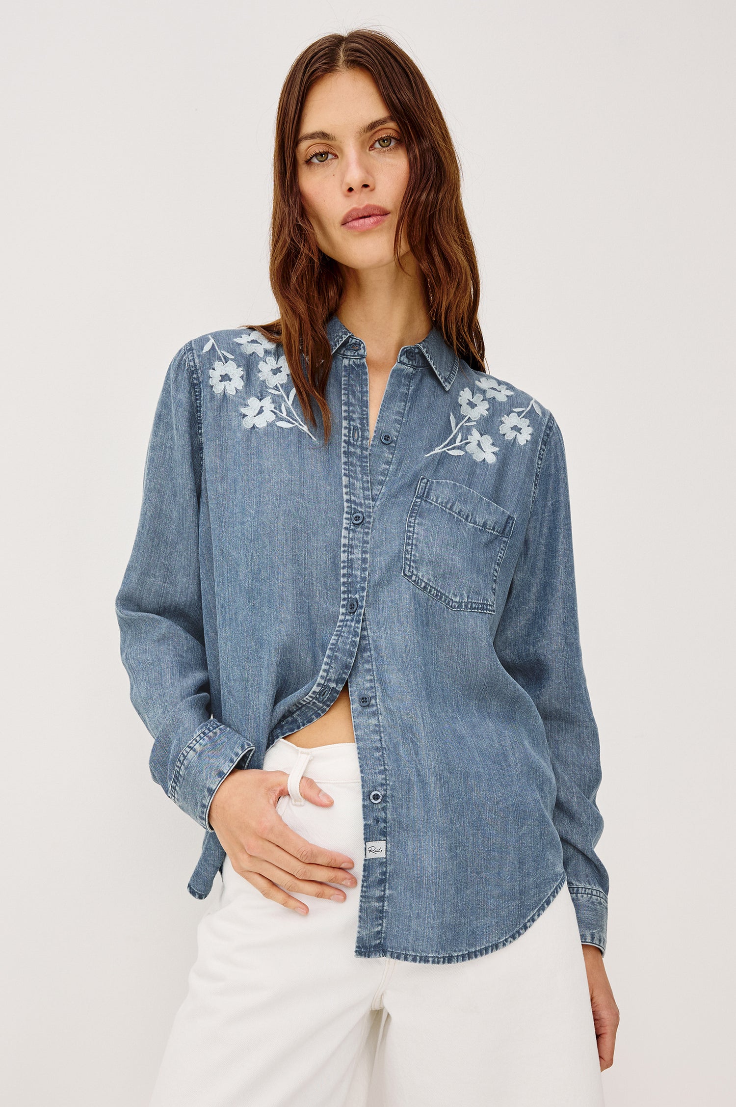 Ingrid Button-Up Collared Shirt in TENCEL™Denim With Vintage-Inspired Wash, Floral Embroidery, a Chest Patch Pocket, and Long Sleeves in Fleur Embroidery Colorway - Upper Body Front View Featured on Model