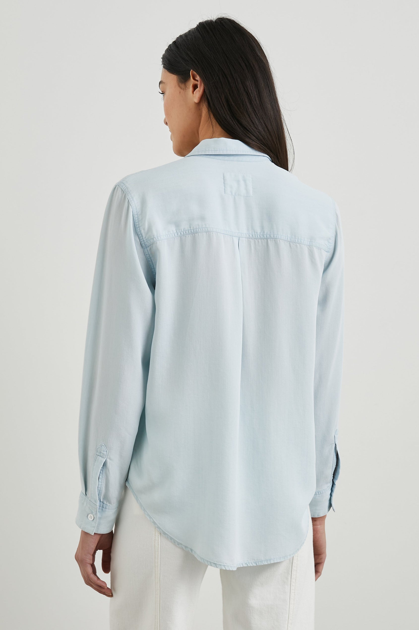 Ingrid Long Sleeve Denim Button Up with a Chest Patch Pocket in Light Vintage Colorway - Back View Featured on Model